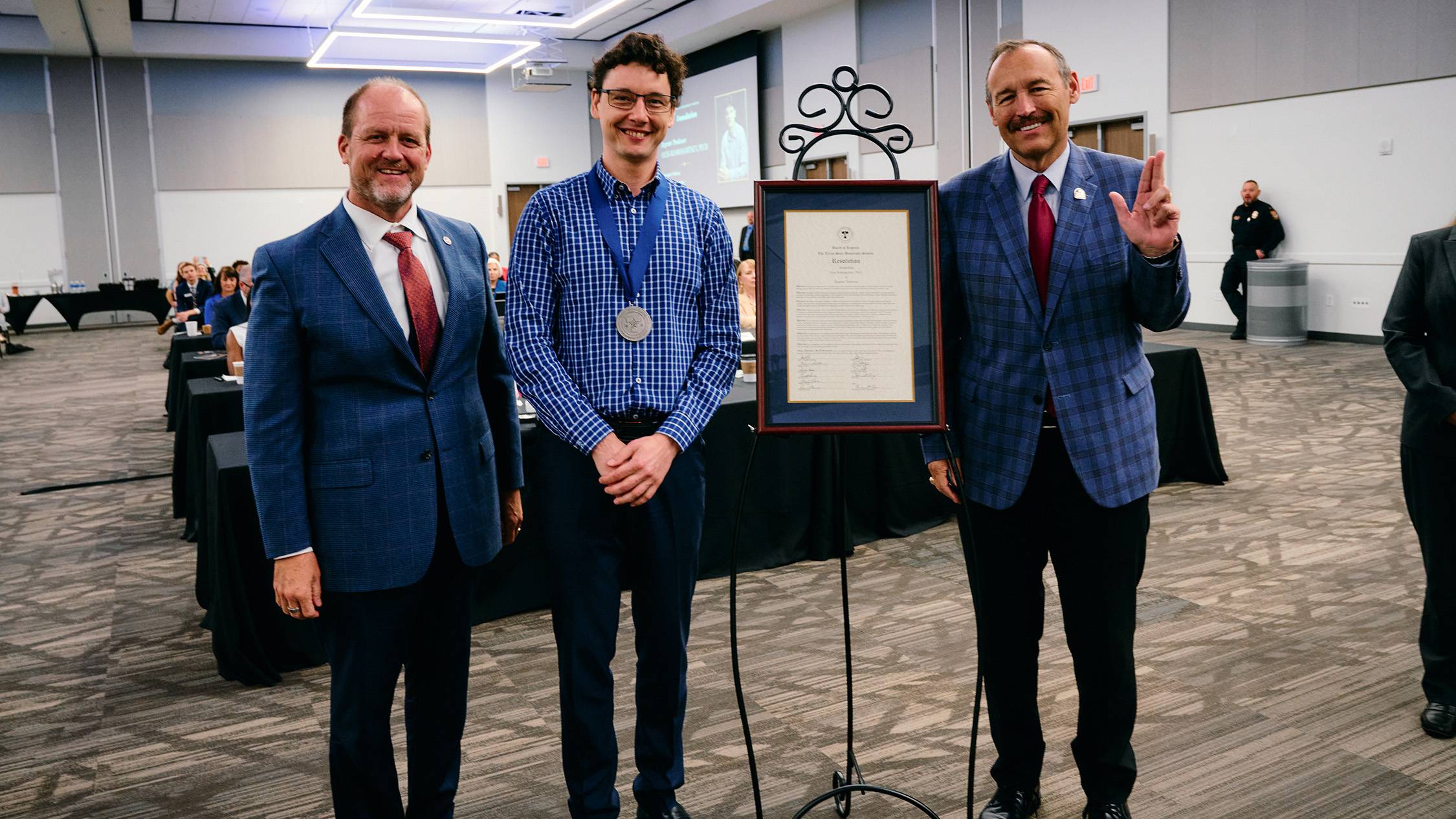 Komogortsev and President Damphousse pose for a photo.
