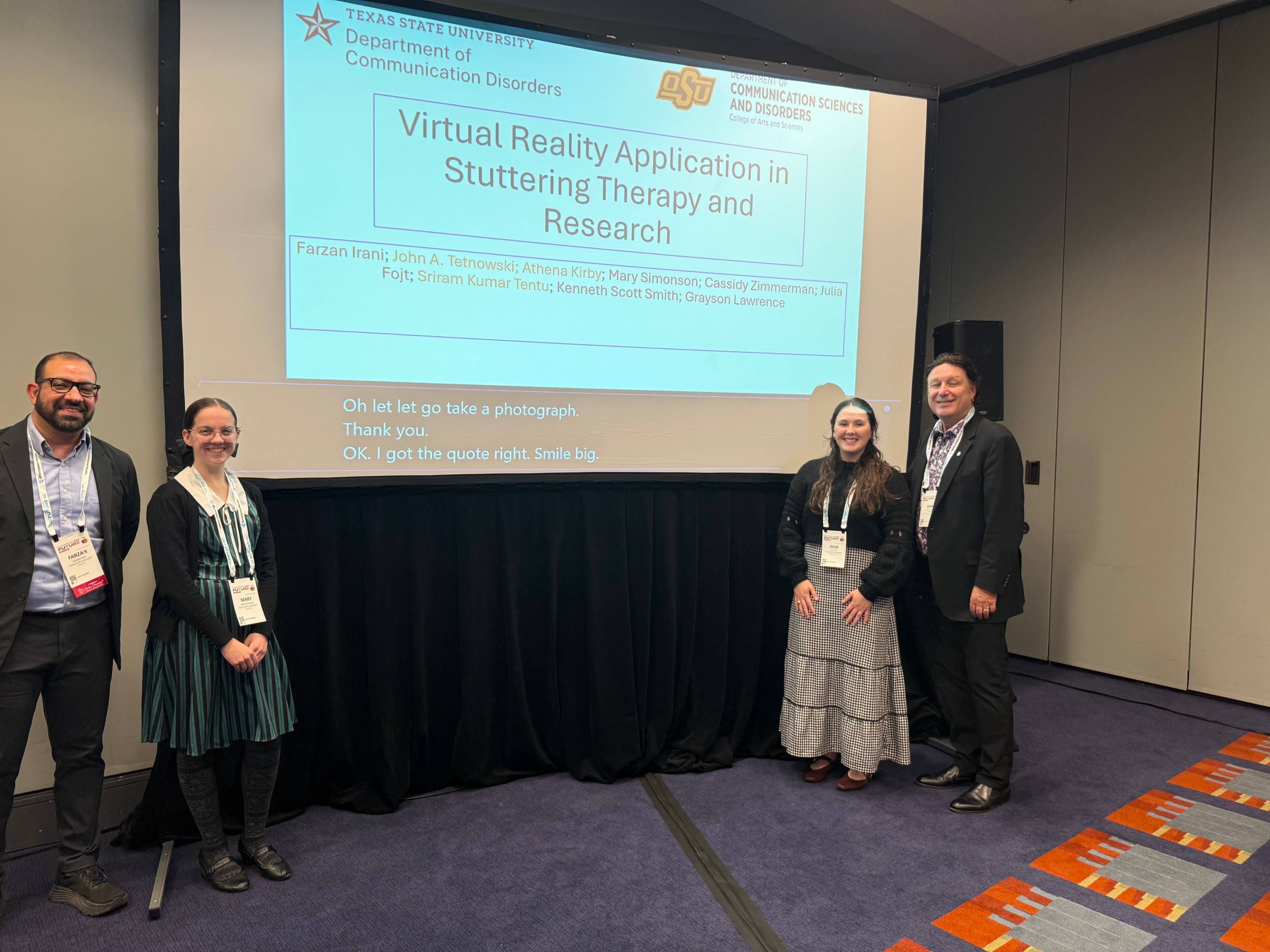 Dr. Irani standing next to other two CDIS students during the presentation.