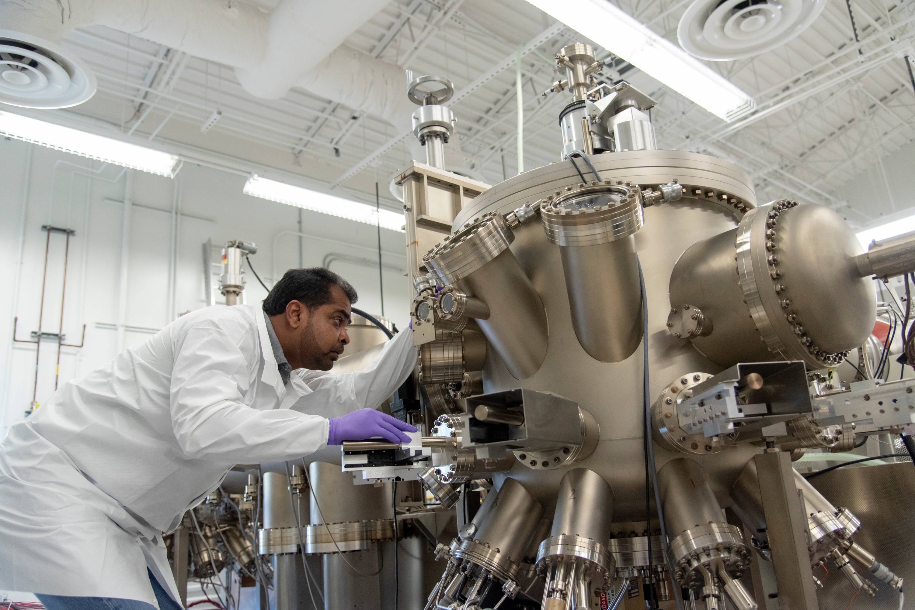 Student examining lab equipment