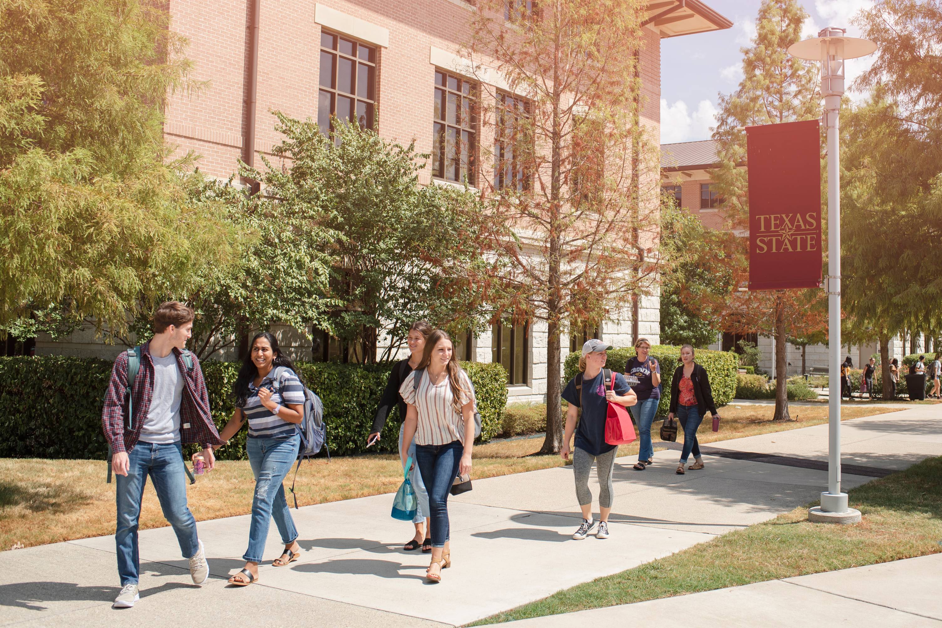 students walking on sidewalk of txst round rock campus