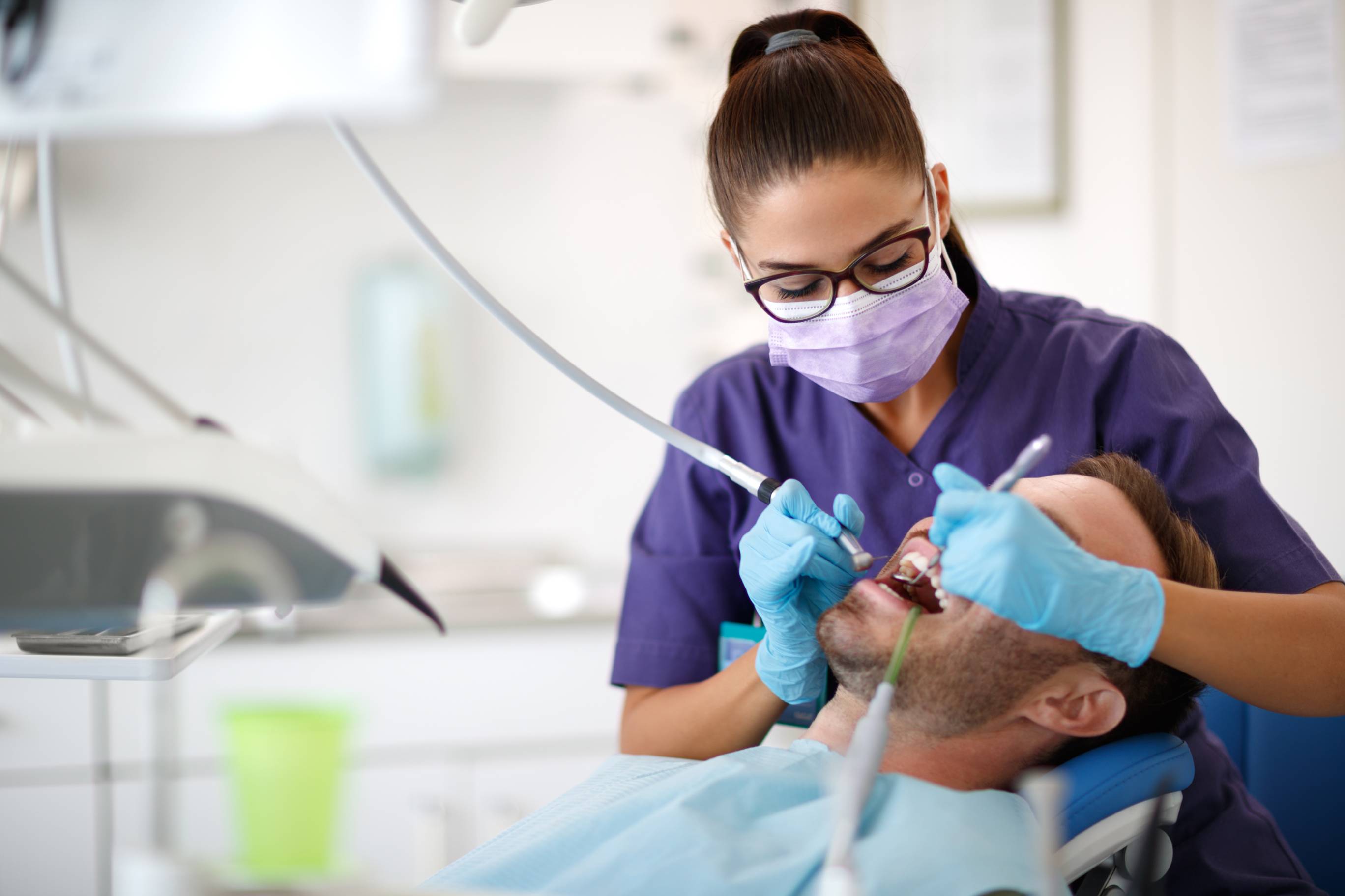 a dental assistant working on a patient