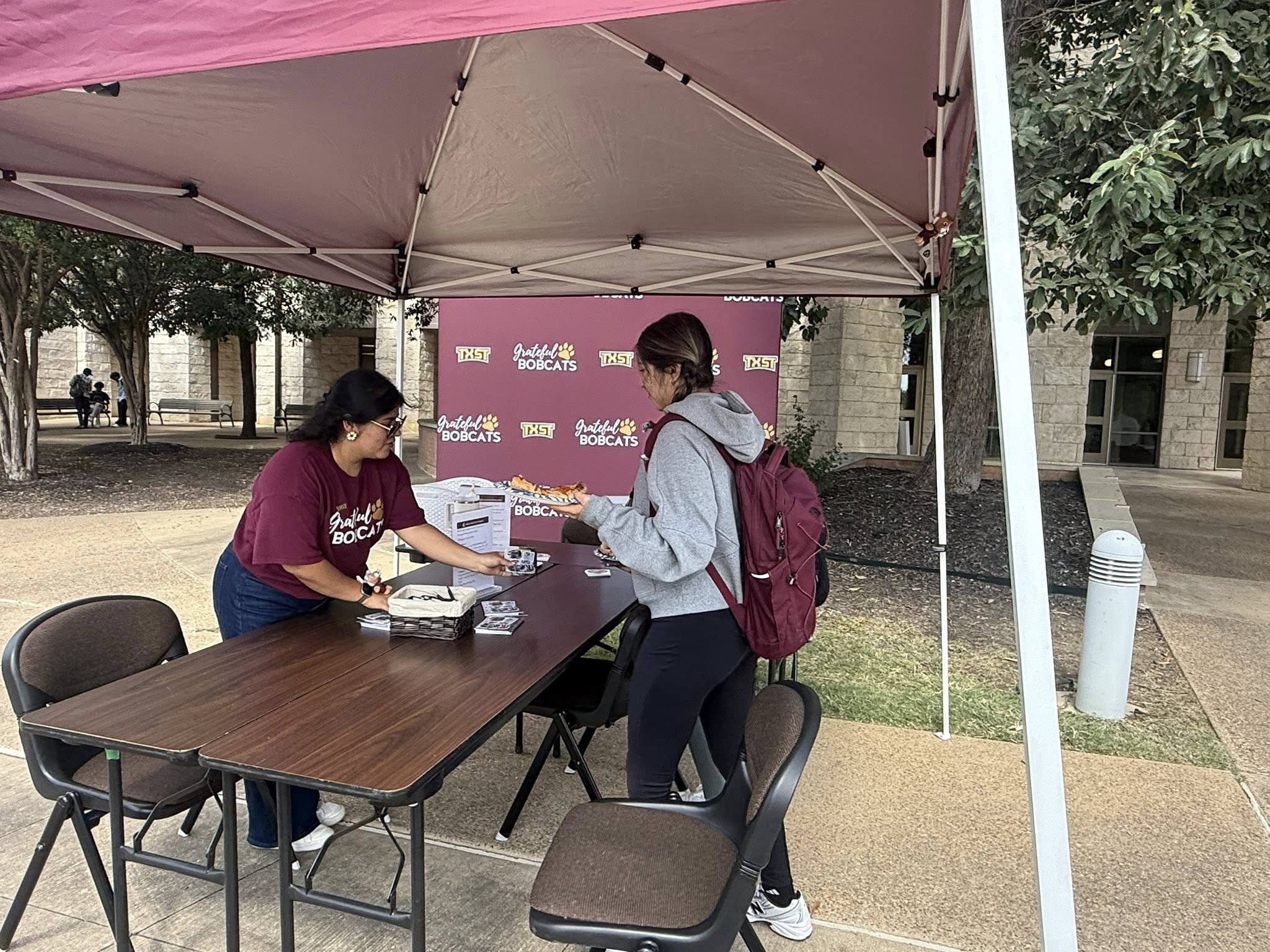 a student talking to a staff