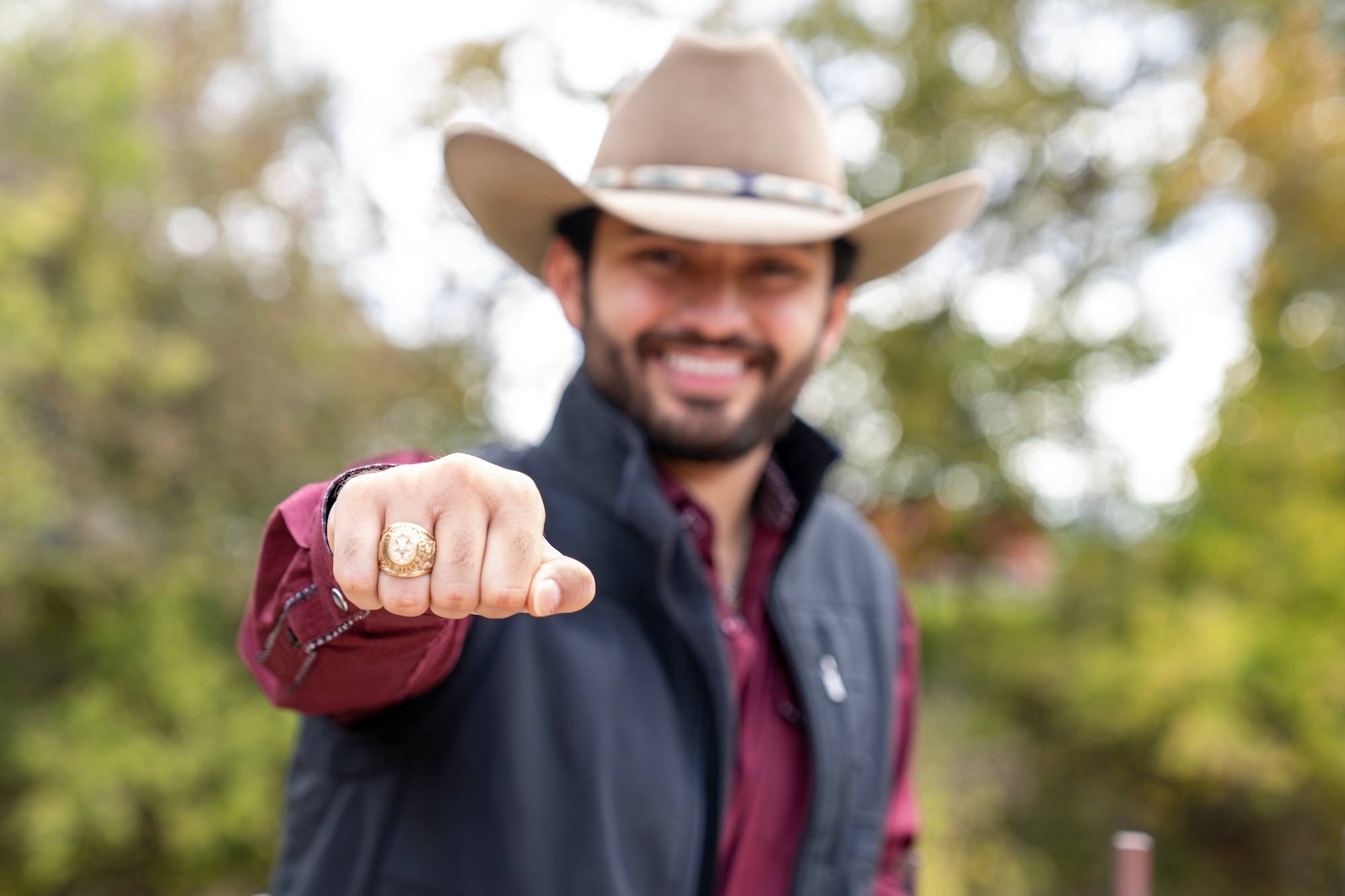 Student holding up hand with official Texas State class ring