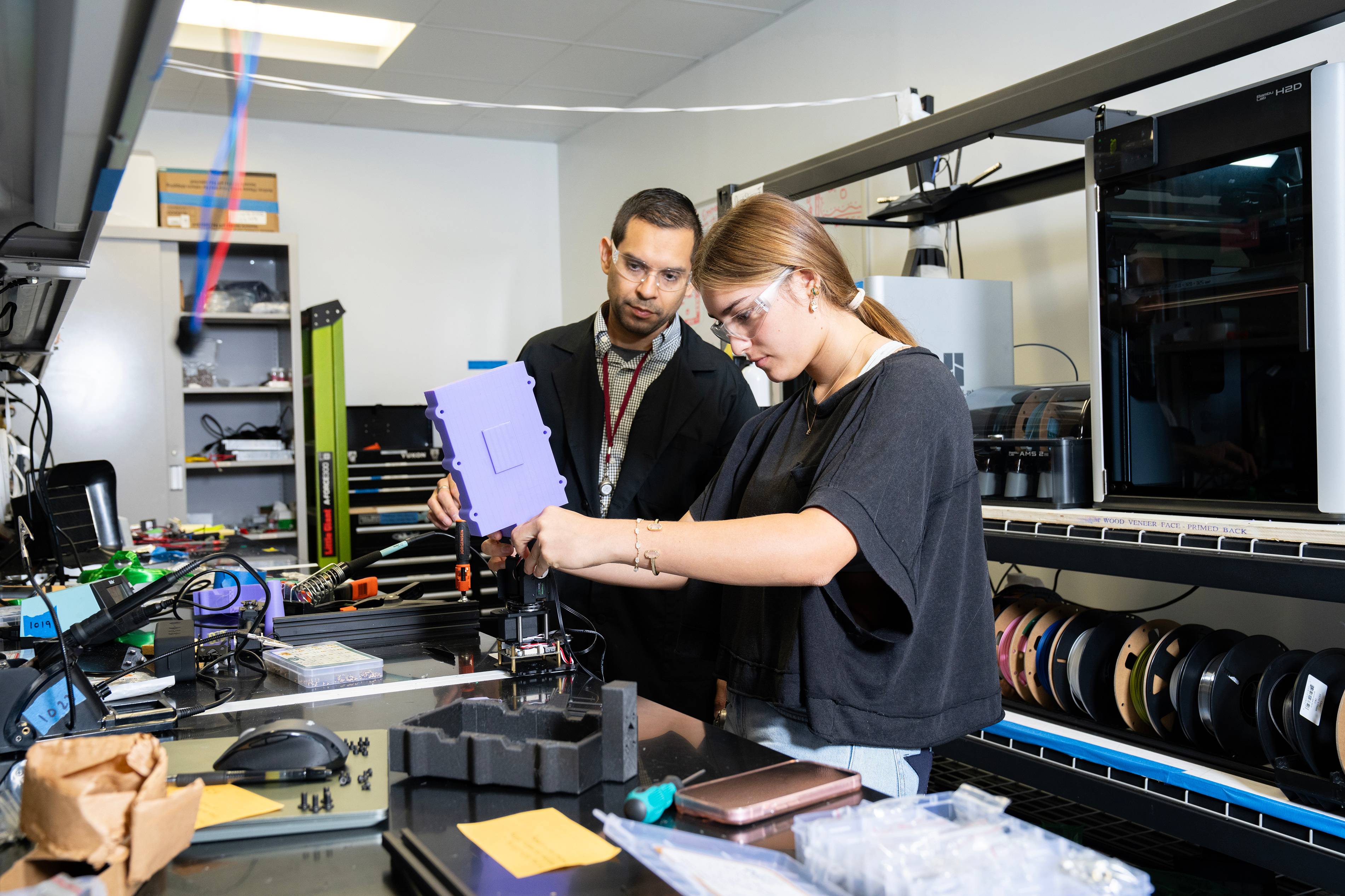 chris reyes and female student working in lab setting