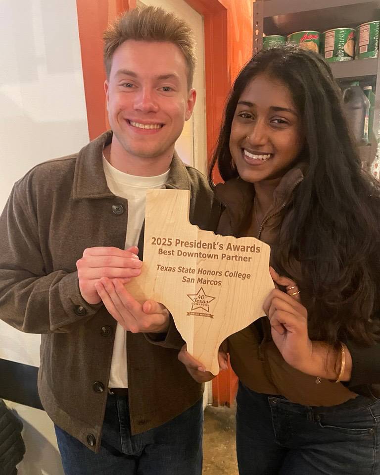 TXST Honors College students pose for a photo with the award.