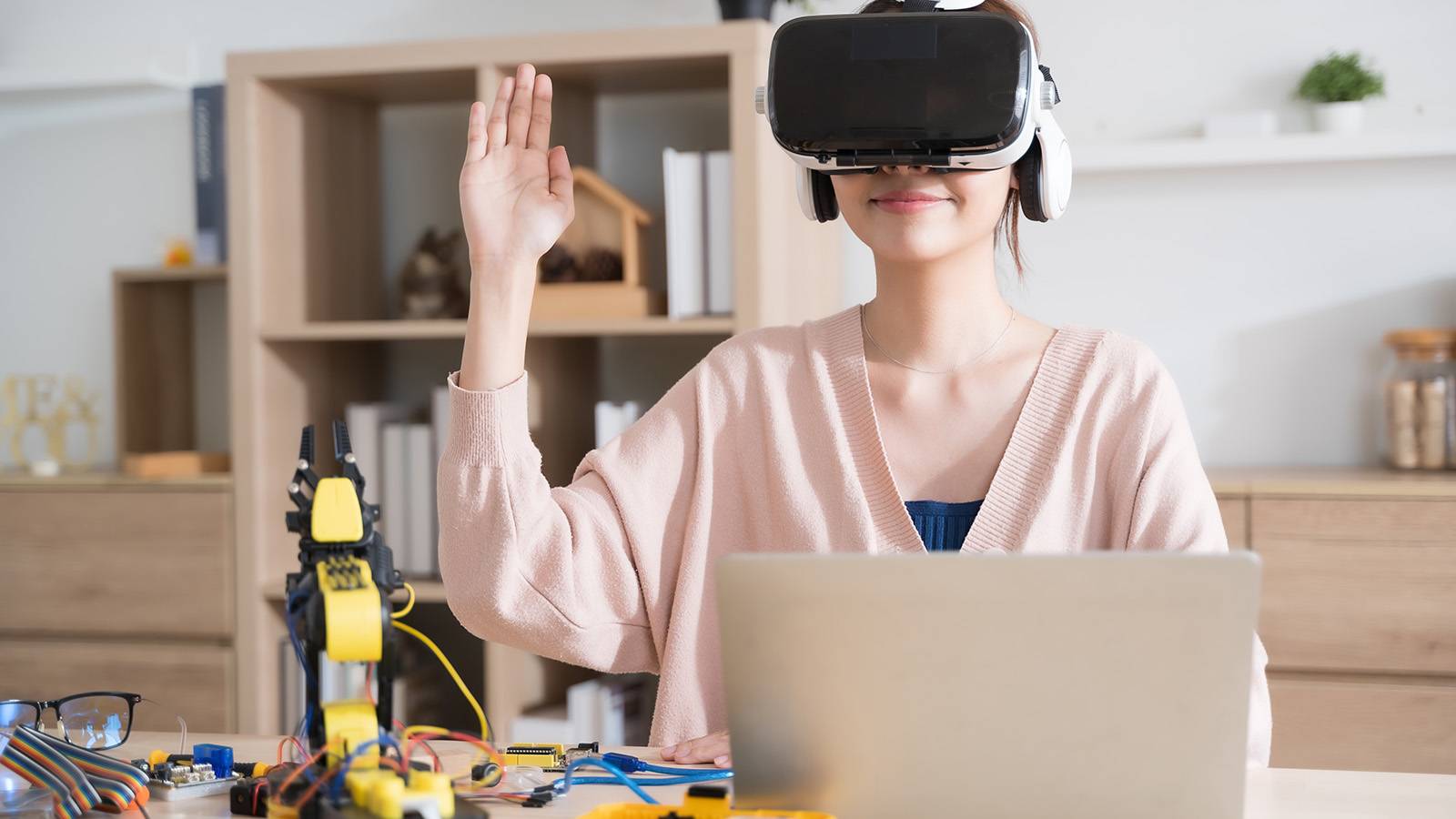 student wearing virtual reality headset while working on a project