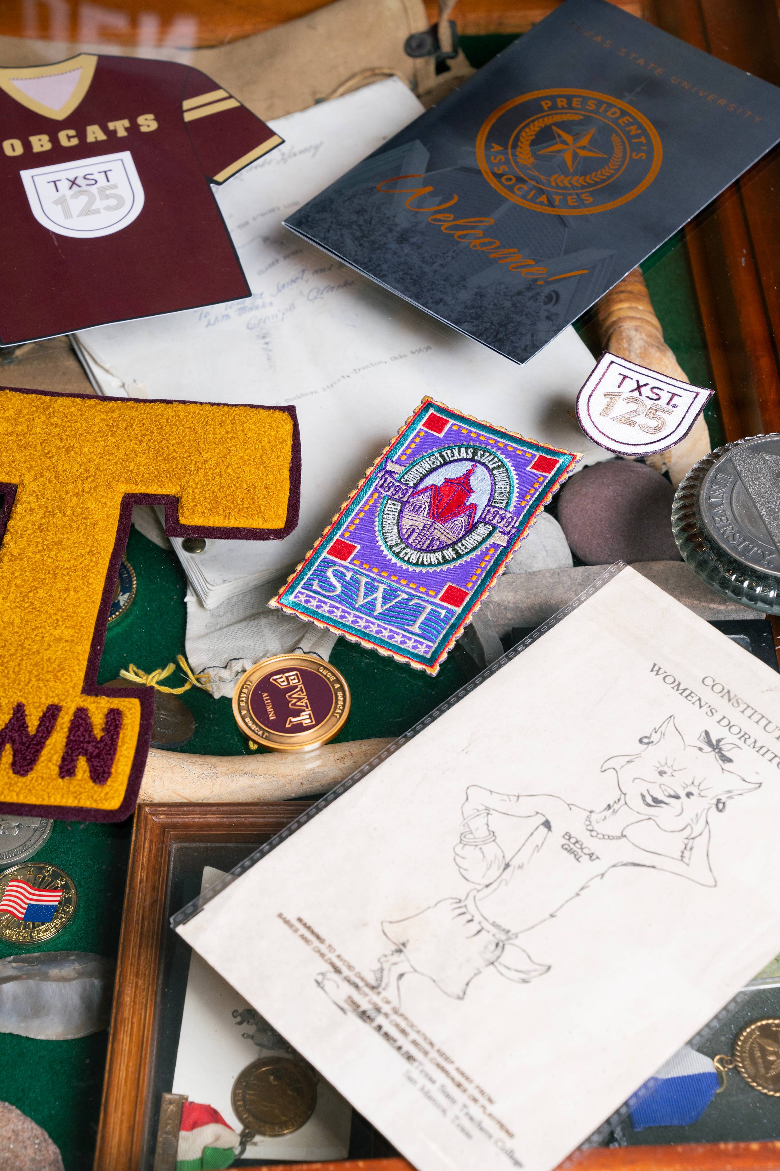 Texas State University memorabilia sitting on a glass table