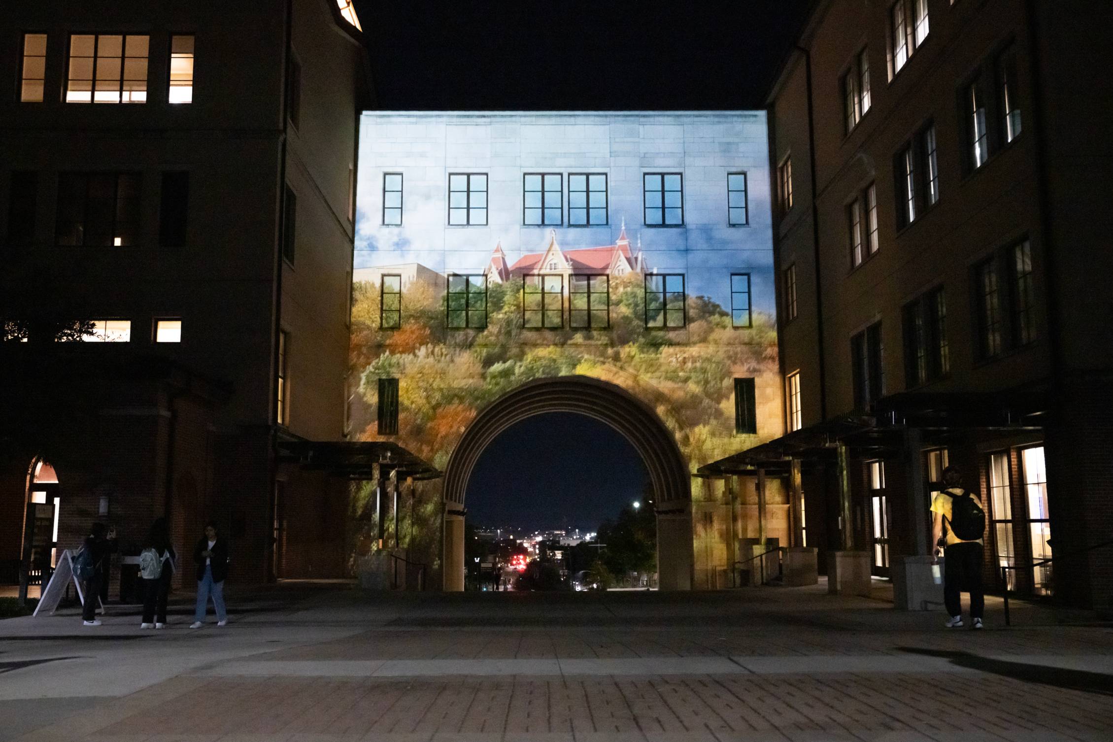An image of the university arch at night