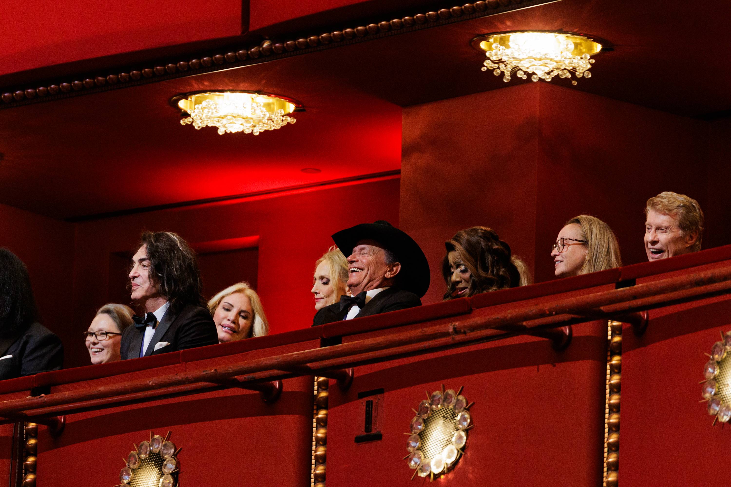 kennedy center honorees sitting in an elevated level of a elegant performance center