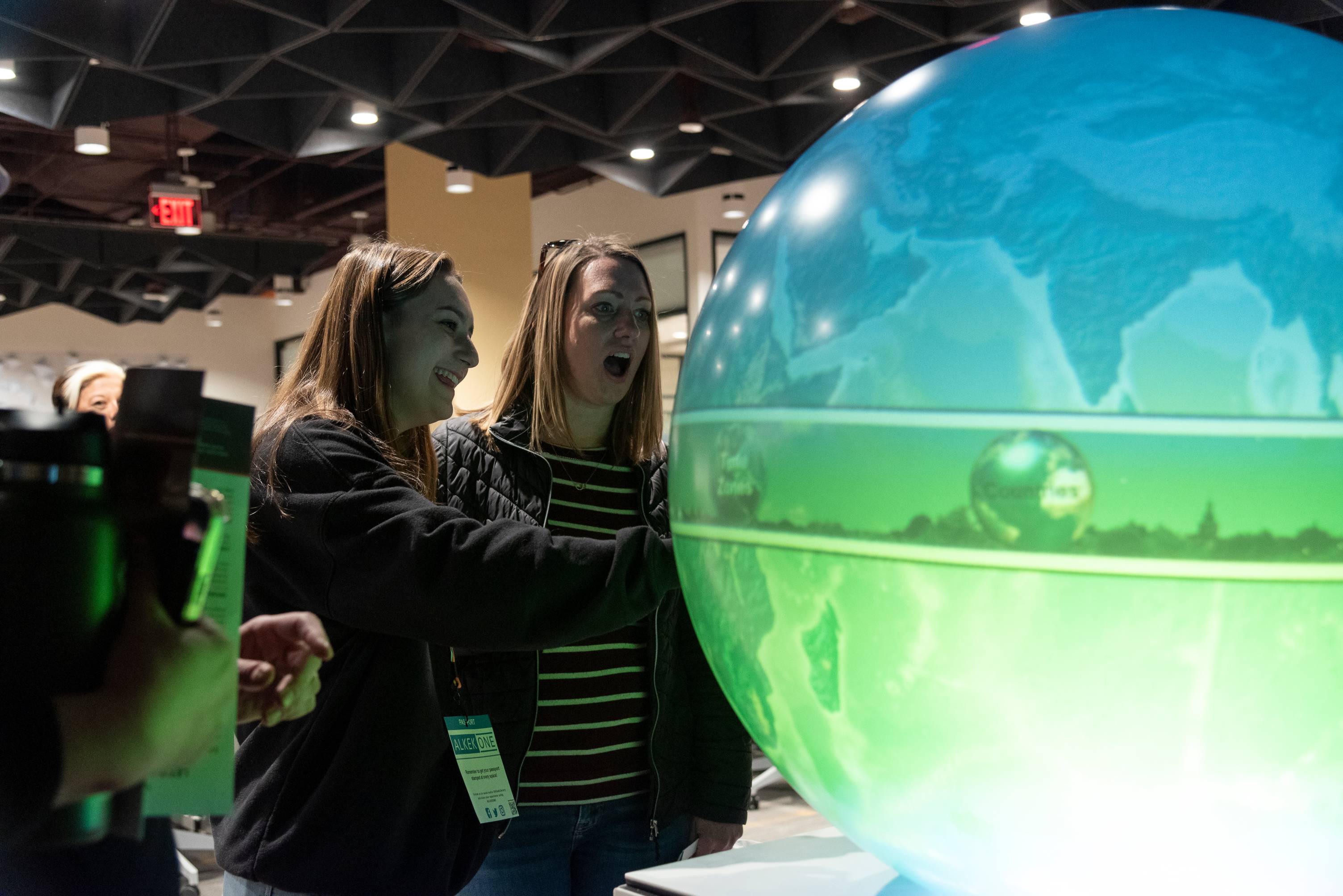 Students looking a large globe