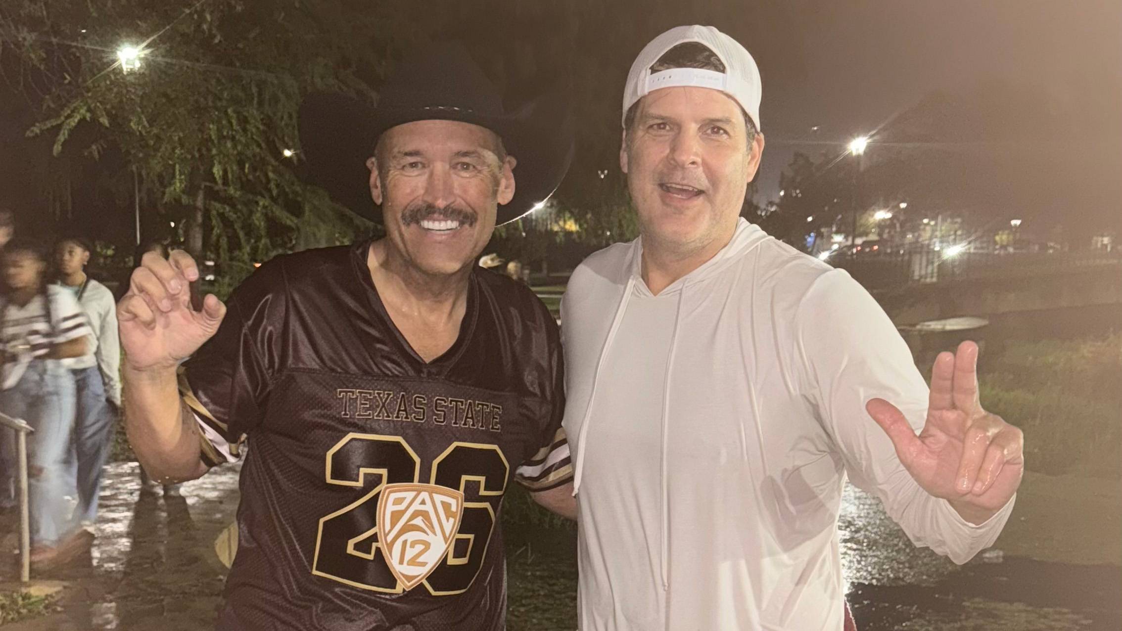 President Kelly Damphousse (left) poses for a photo with Don Coryell after jumping in the river.