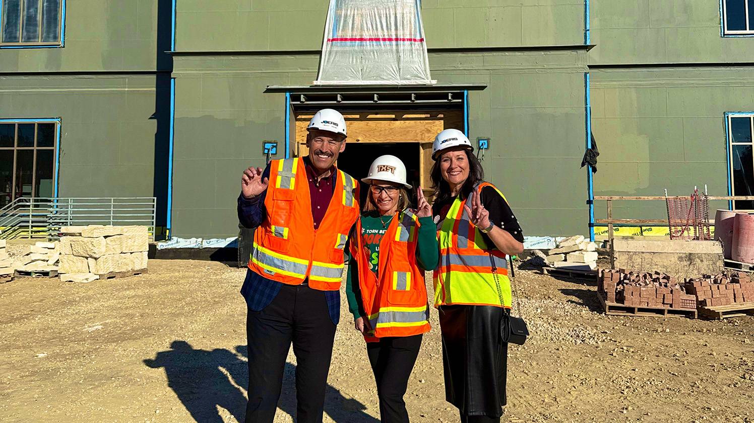 President Kelly Damphousse (left) poses for a photo with Julie Lessiter and First Lady Beth Damphousse.