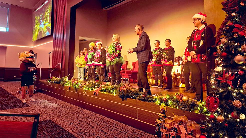President Kelly Damphousse and staff and faculty members celebrate the holidays in the LBJ Student Center.