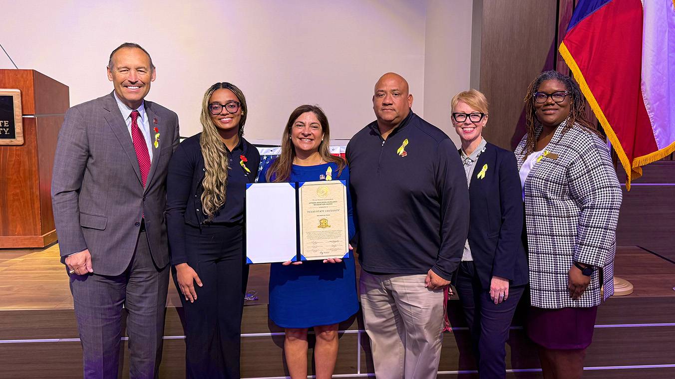 President Kelly Damphouse (left) poses for a photo with veterans and TXST leadership.