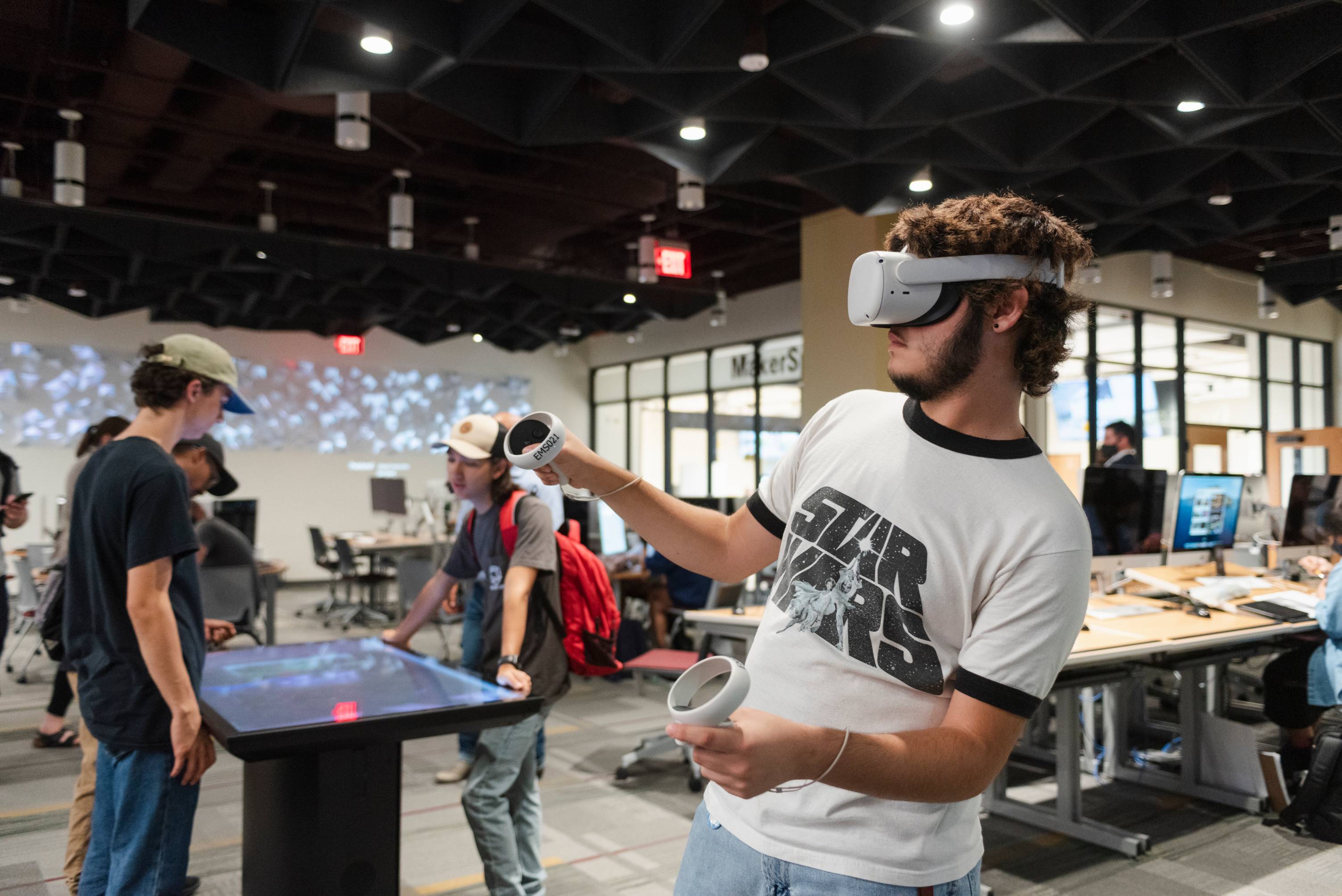 Large room filled with students using immersive technologies