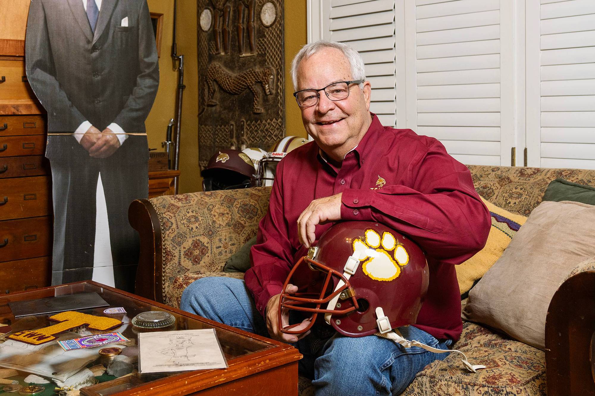 Tom Madden holding a Texas State football helmet