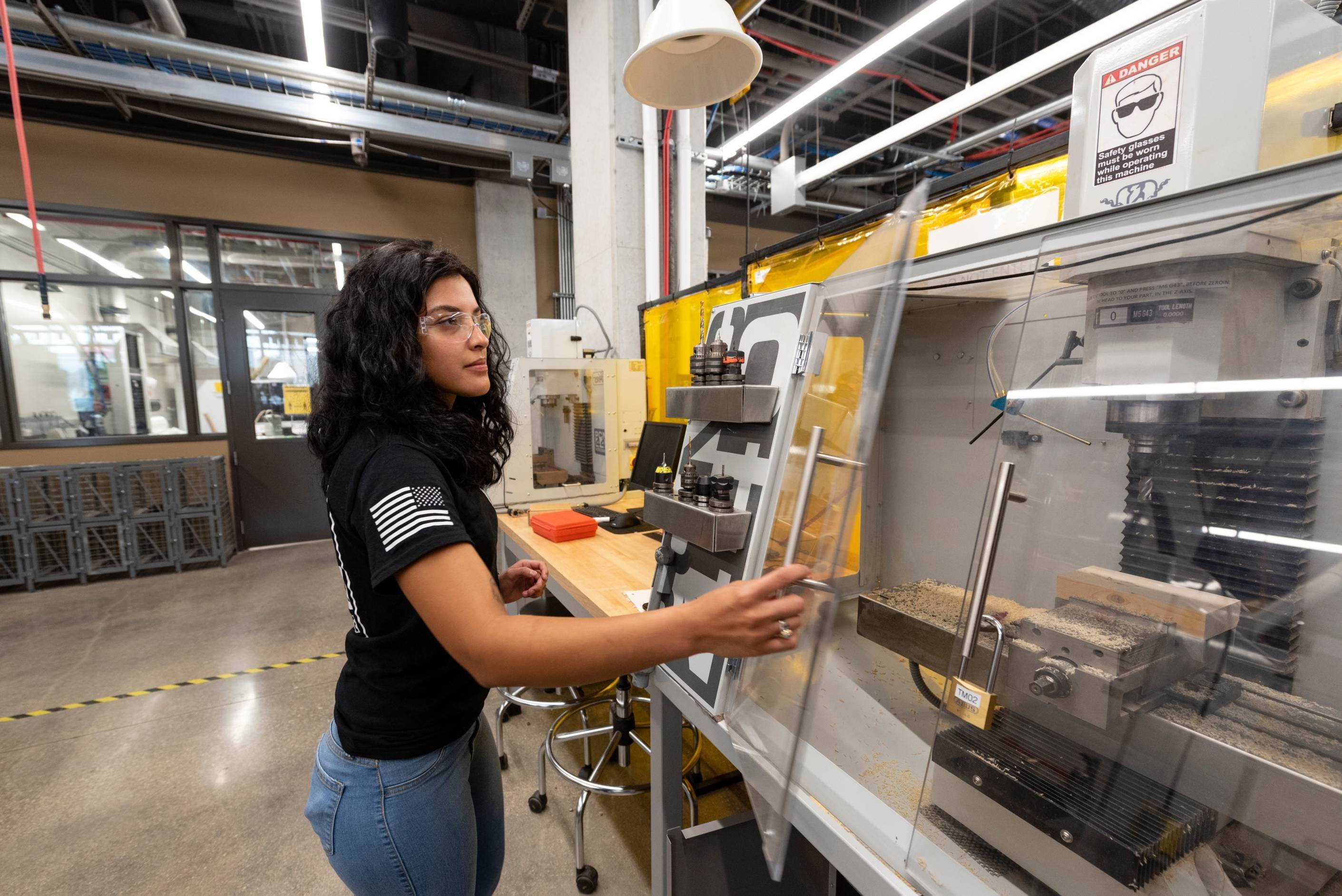 female student working on a machine