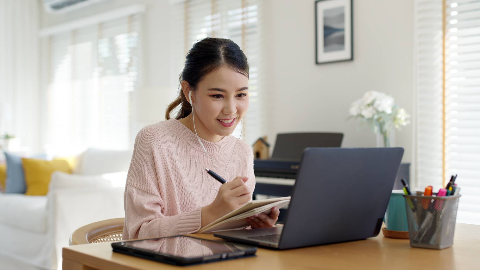 student sitting at desk on laptop