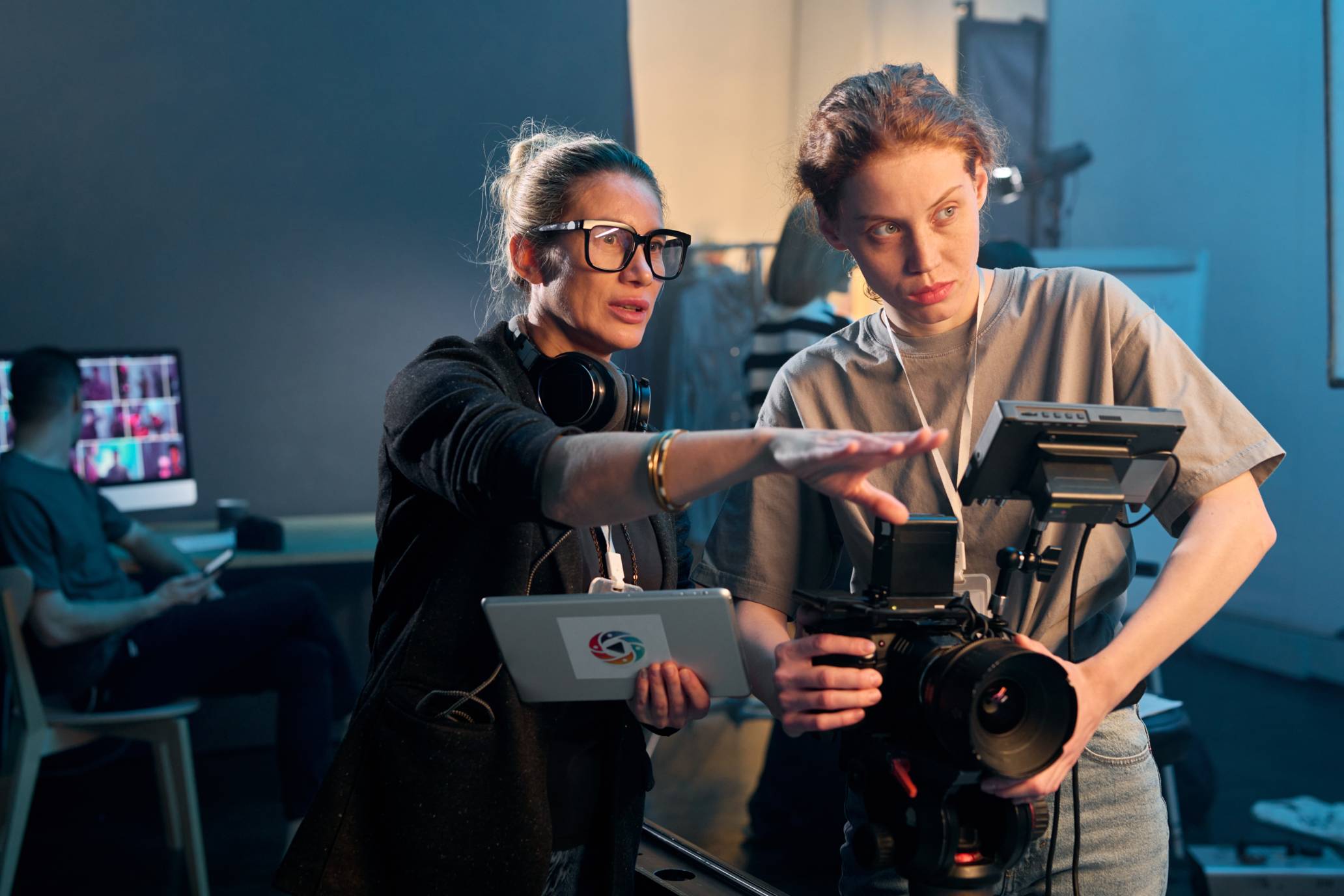 a woman instructing a camera tech on a film set