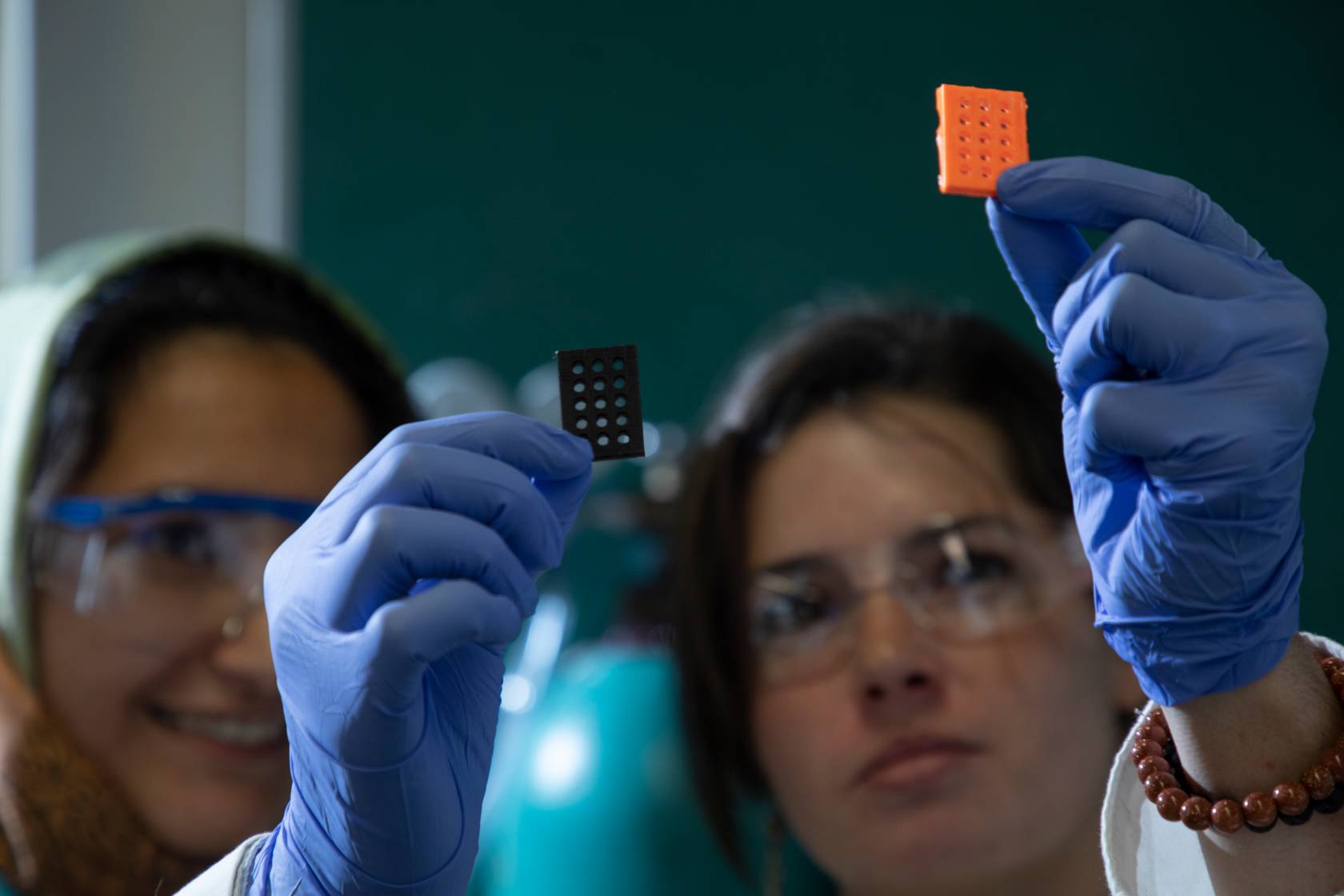 Researchers examining lab sample slide