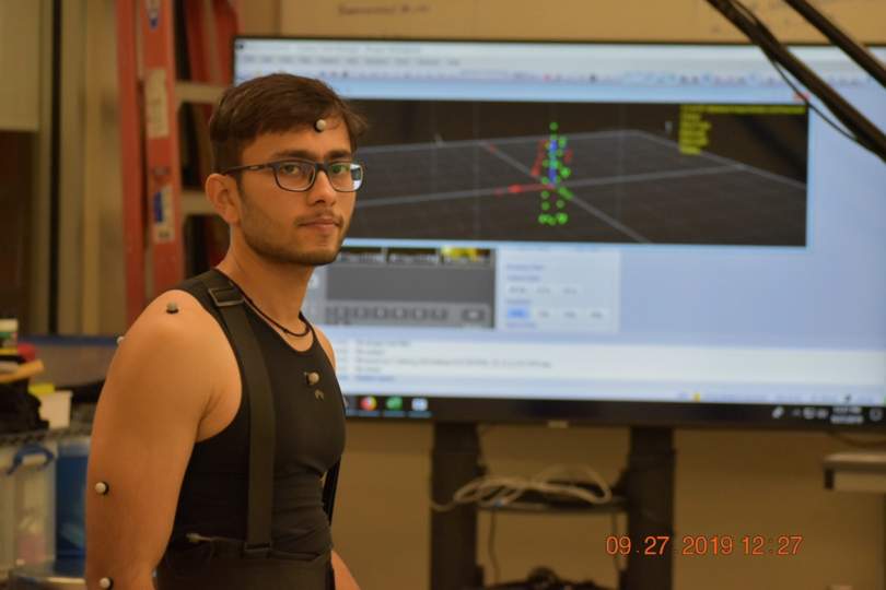 Student wearing reflective markers for an optical motion capture study