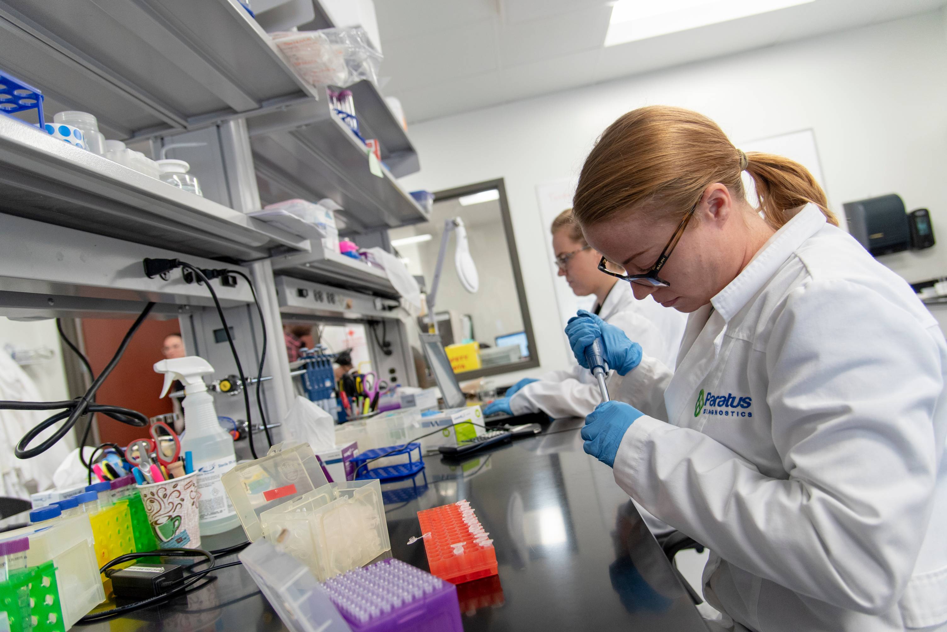 Researchers pipetting samples in laboratory