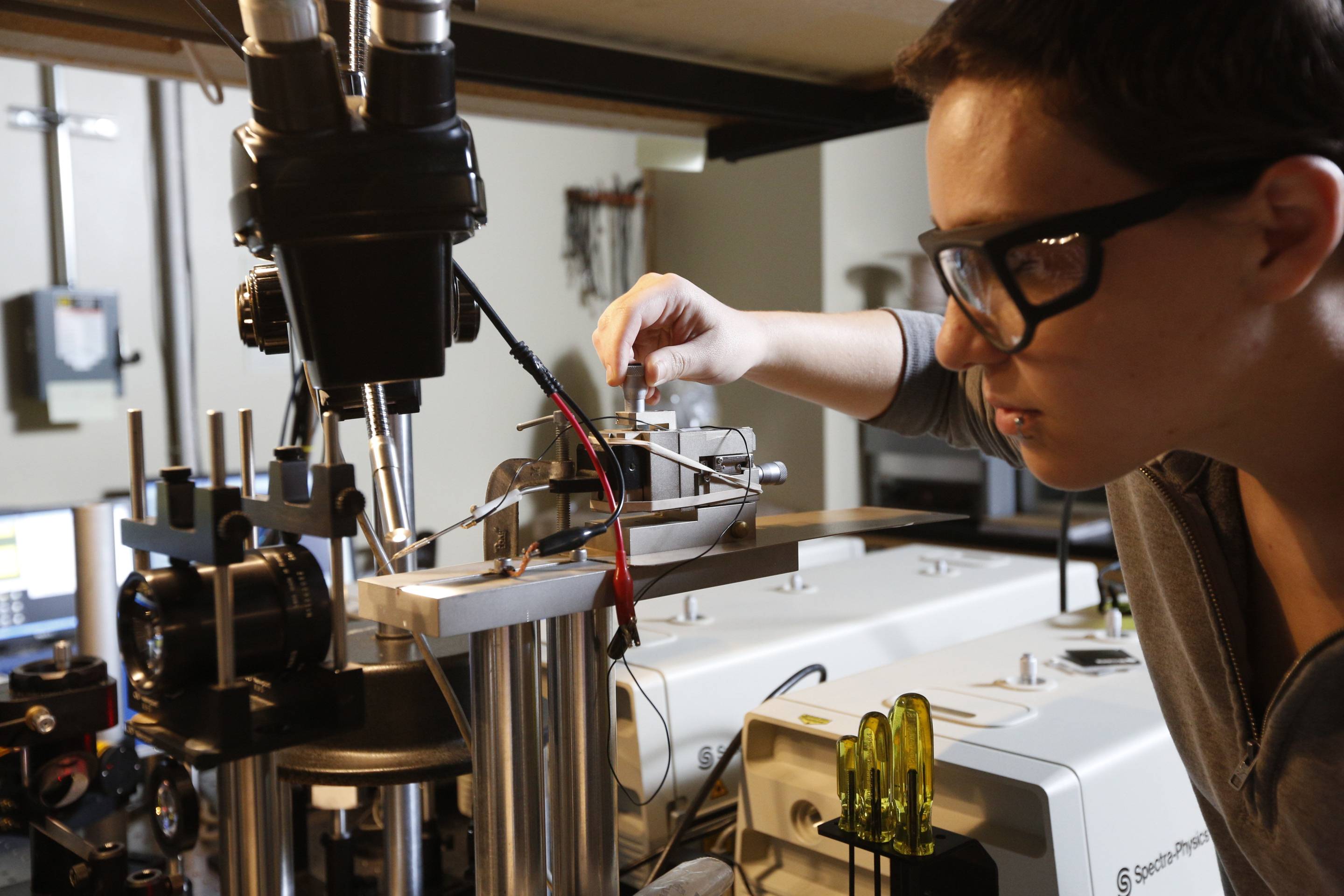 Student adjusts laboratory equipment during a hands-on research experiment