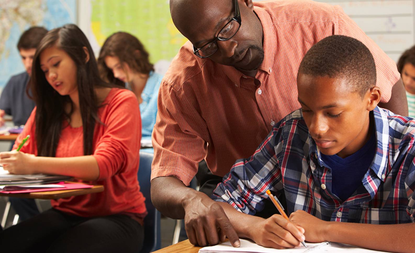 a teacher helping a student in a classroom