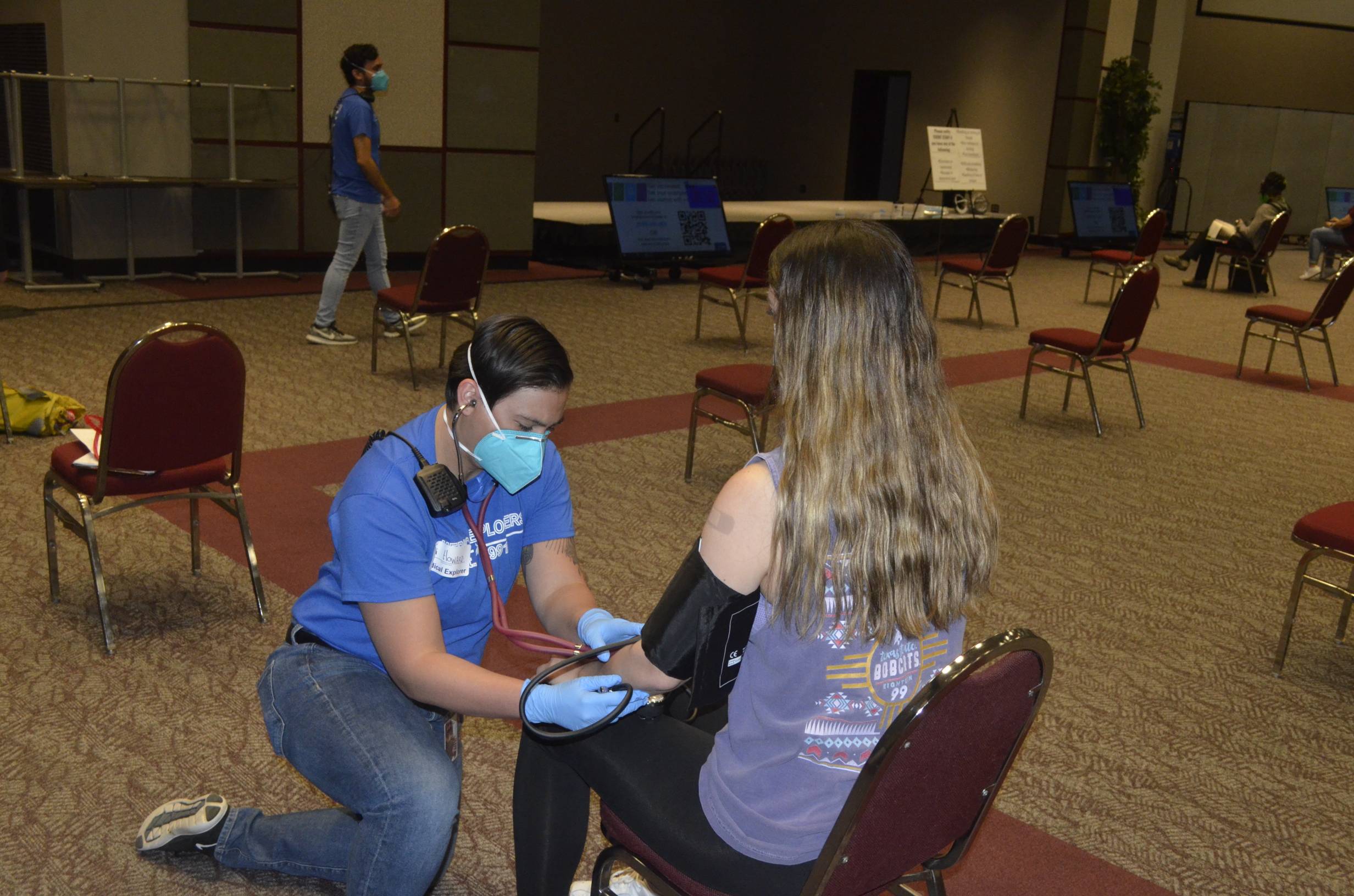 Medical Explorer checking for adverse reactions during a university vaccination clinic