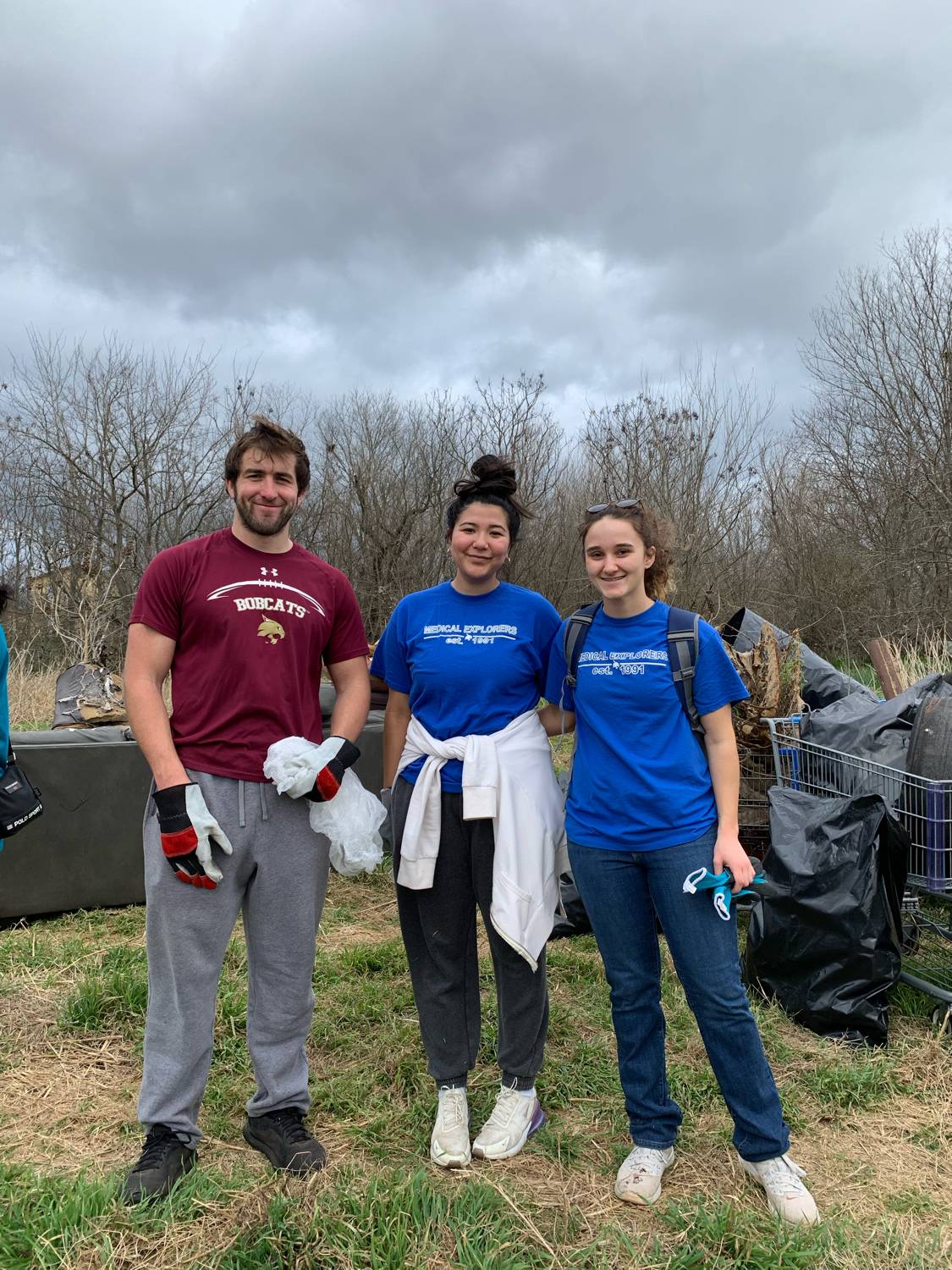 Medical Explorers helping Lions in a river cleanup.