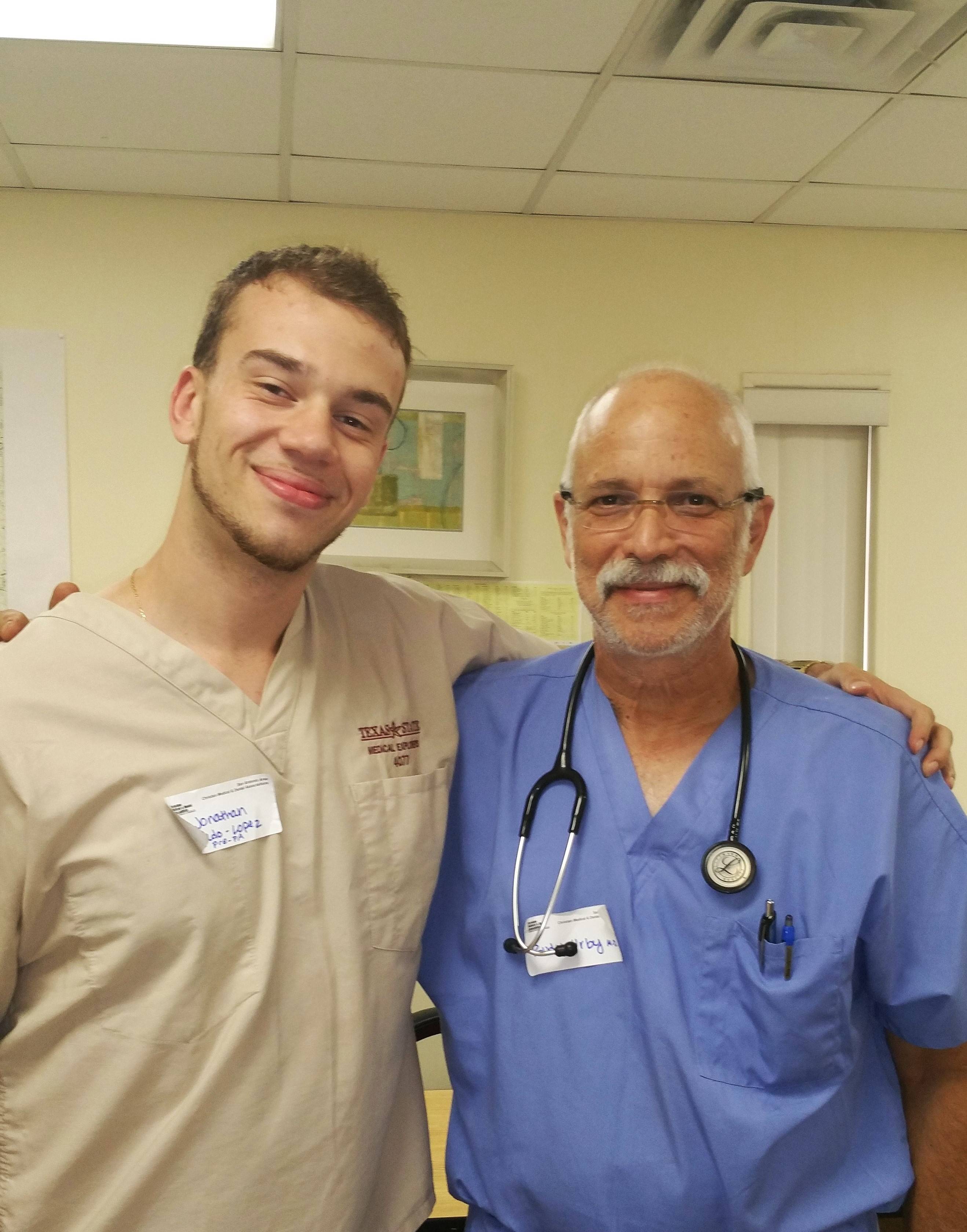 Medical Explorer and pgysician in medical scrubs pose for photo