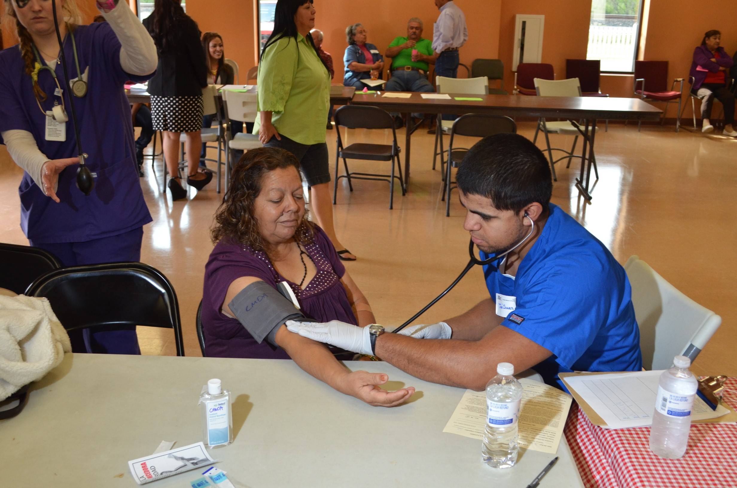 Medical Explorer measuring blood pressure on a medical mission trip