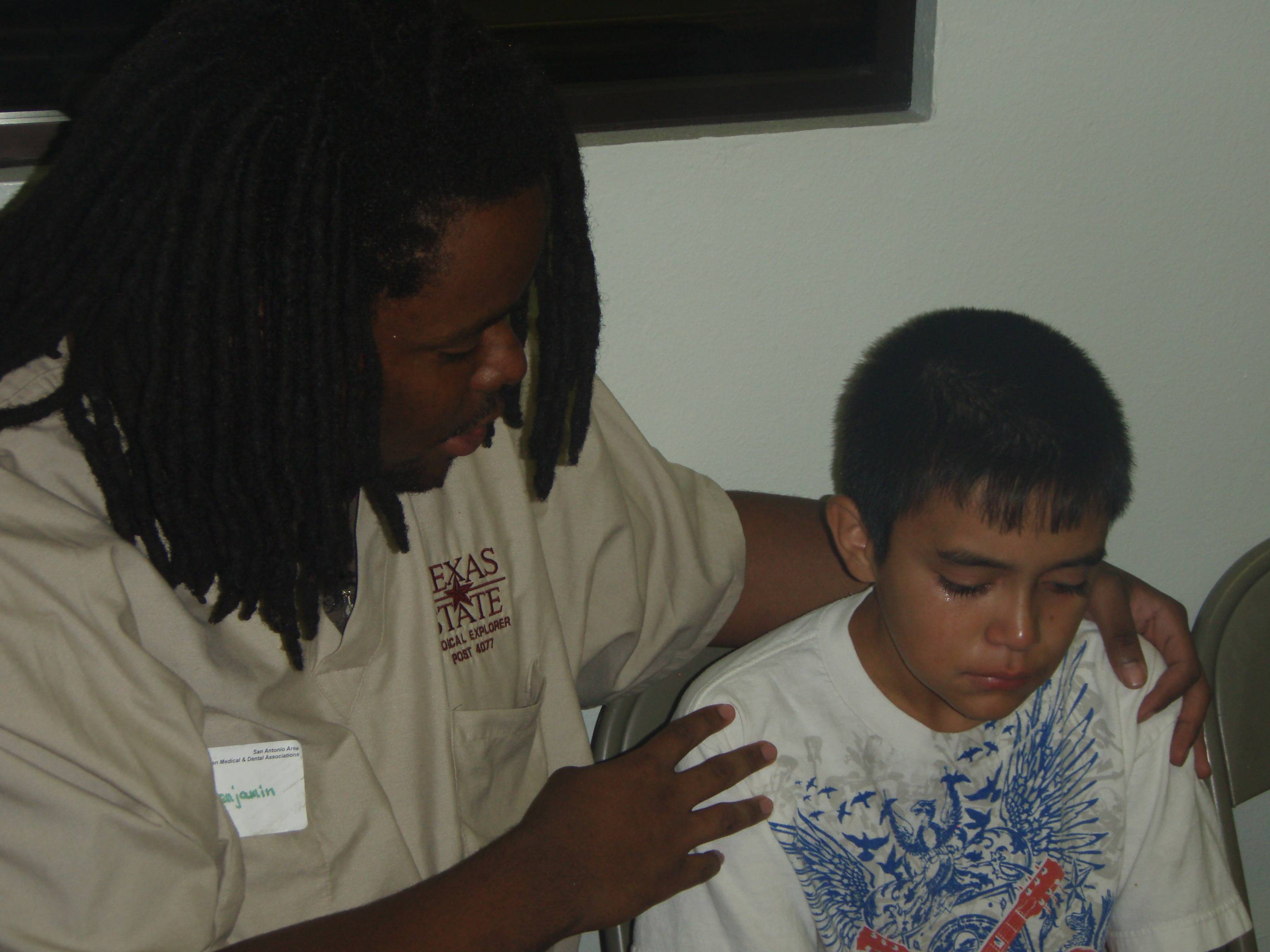 Medical Explorer consoling a child about to receive dental attention 
