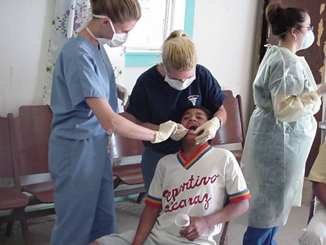 Medical Explorer cleaning teeth on an international medical mission trip
