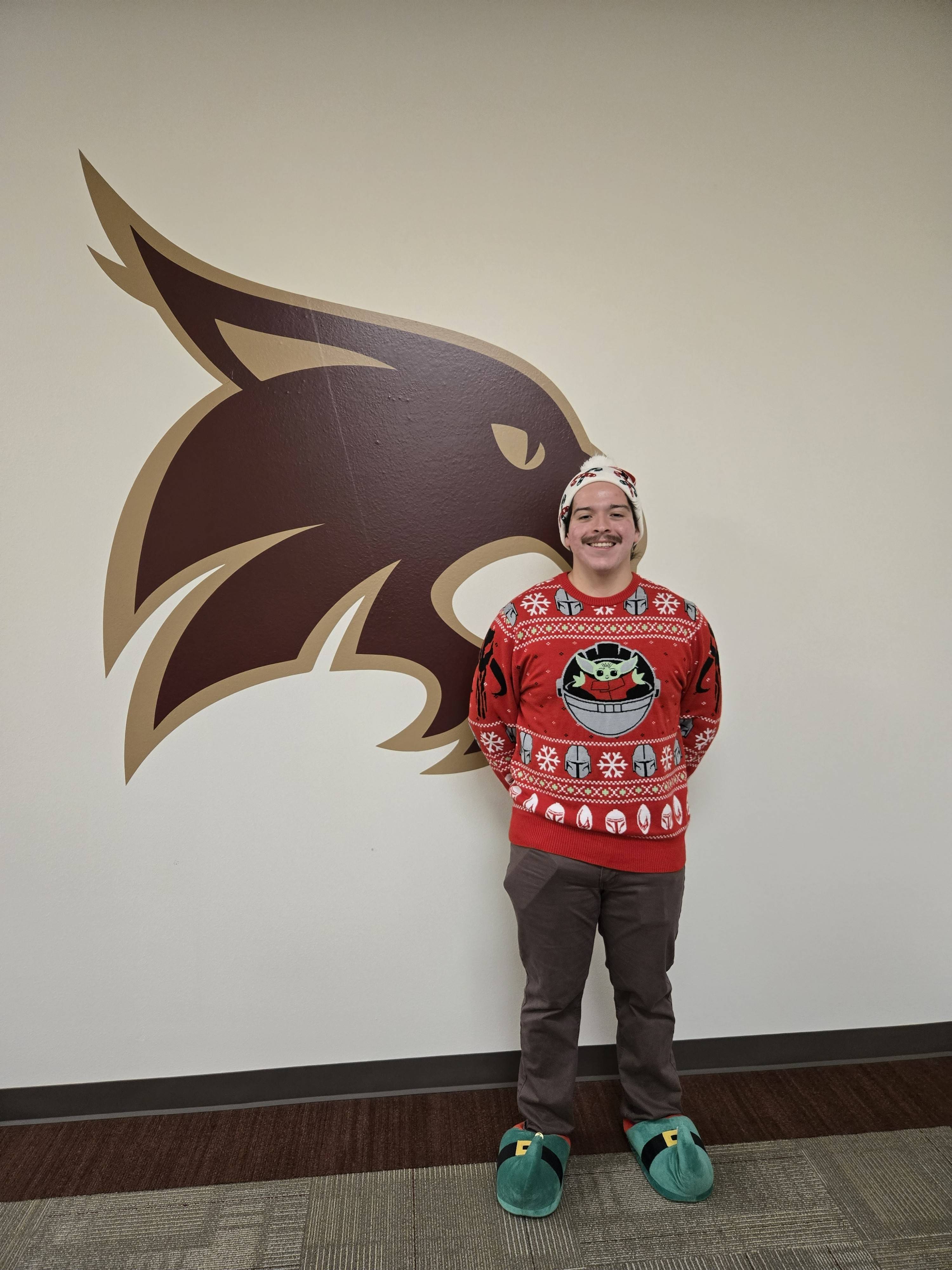 Eli wearing the ugly sweater.