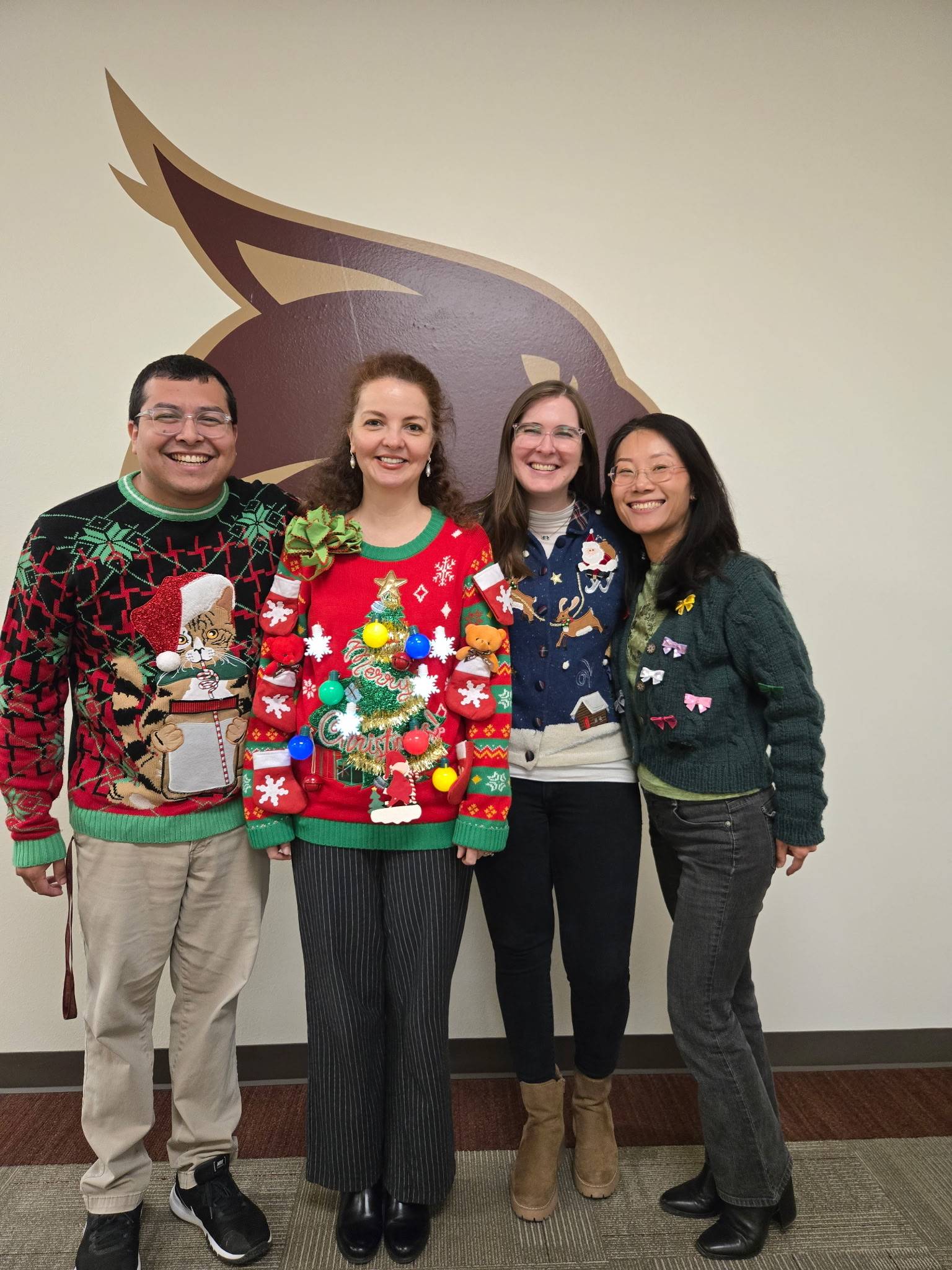 Staff group photo wearing ugly sweaters.