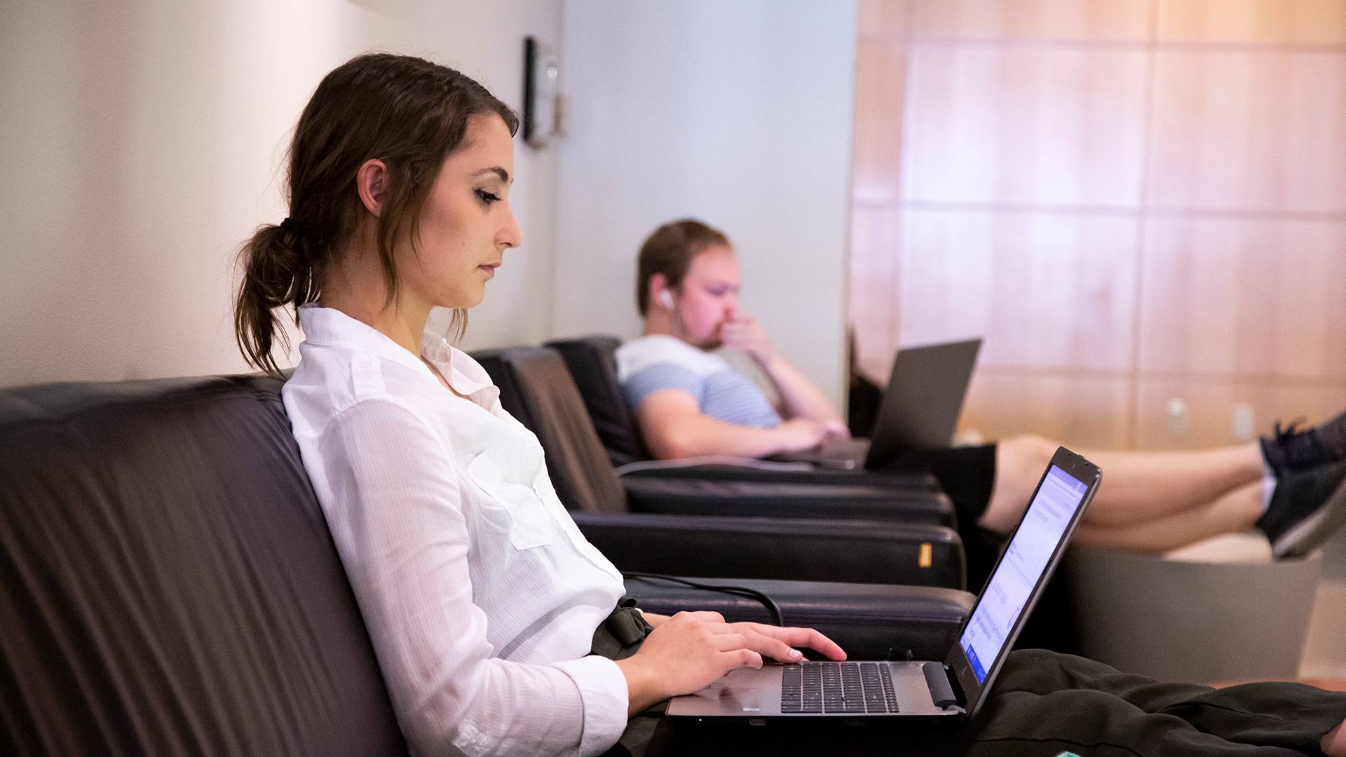 students typing on laptops