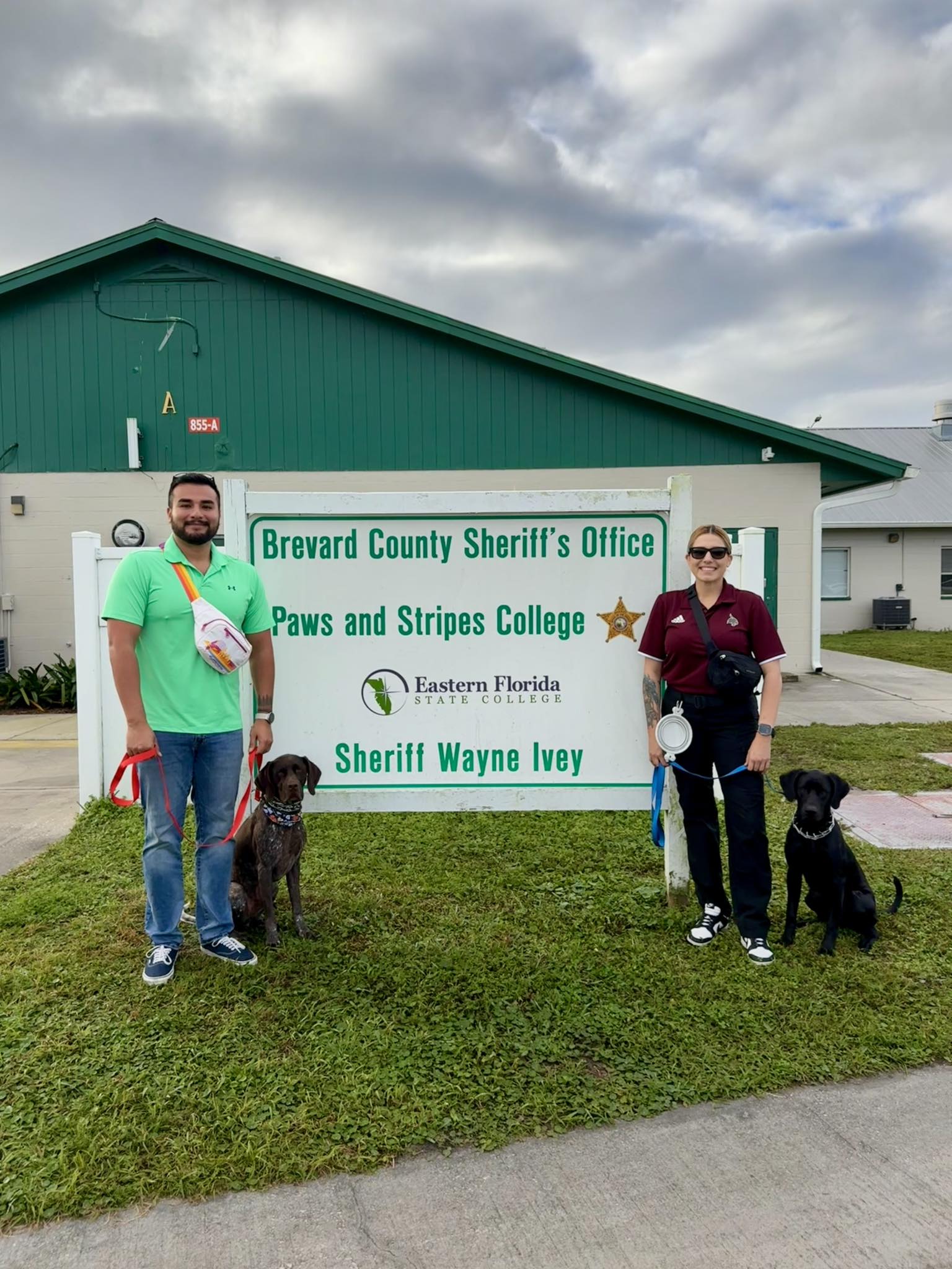 two mental health officers and their therapy dogs outside of the Paws and Stripes College
