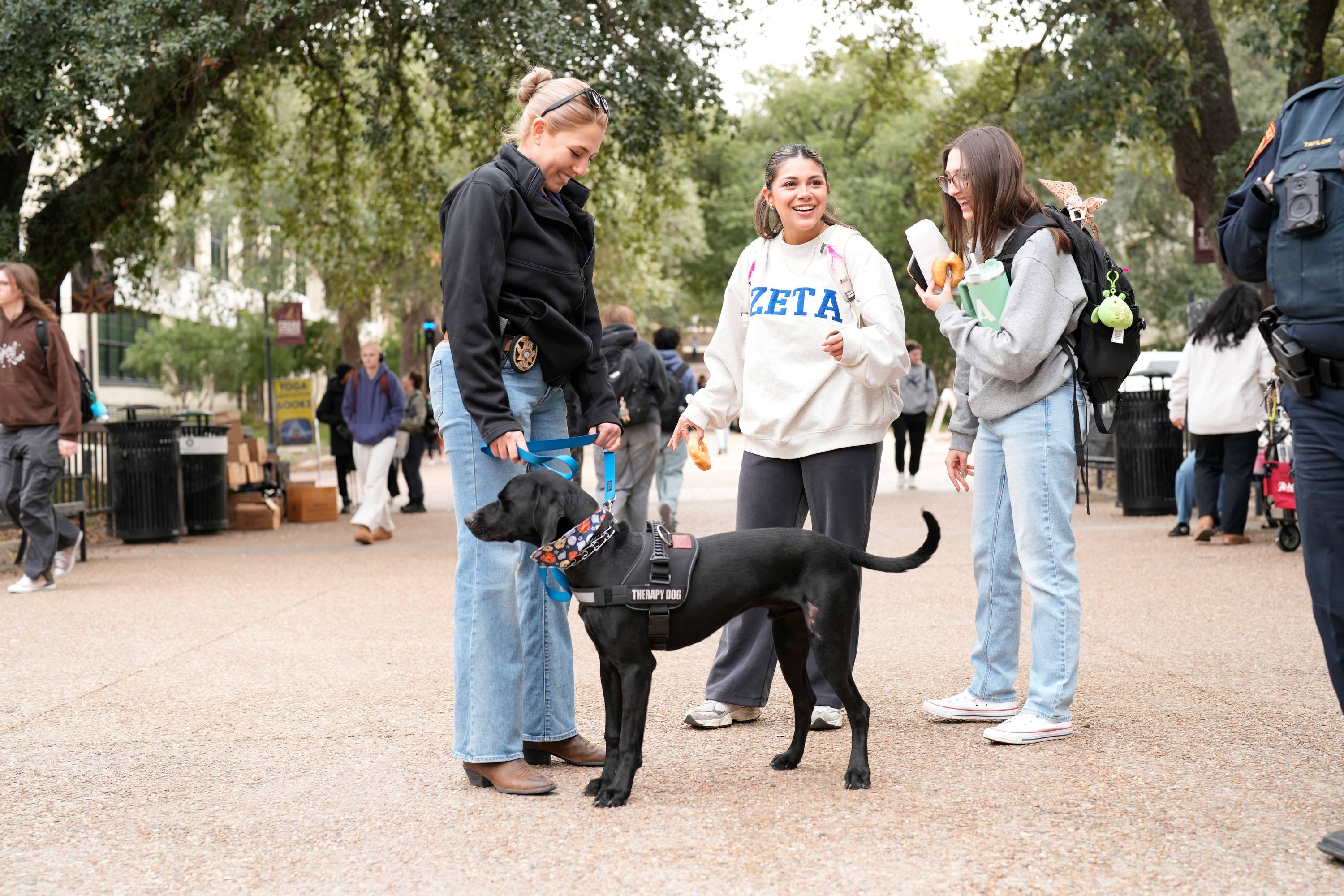 two female students meeting therapy k9 and handler