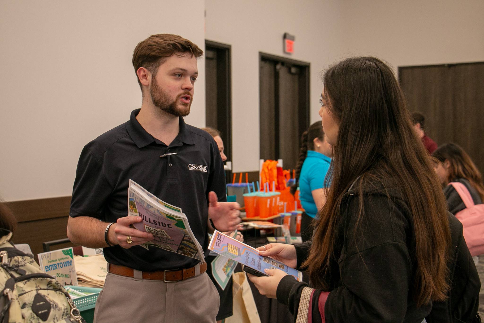 Staff talking to a student about off-campus living options