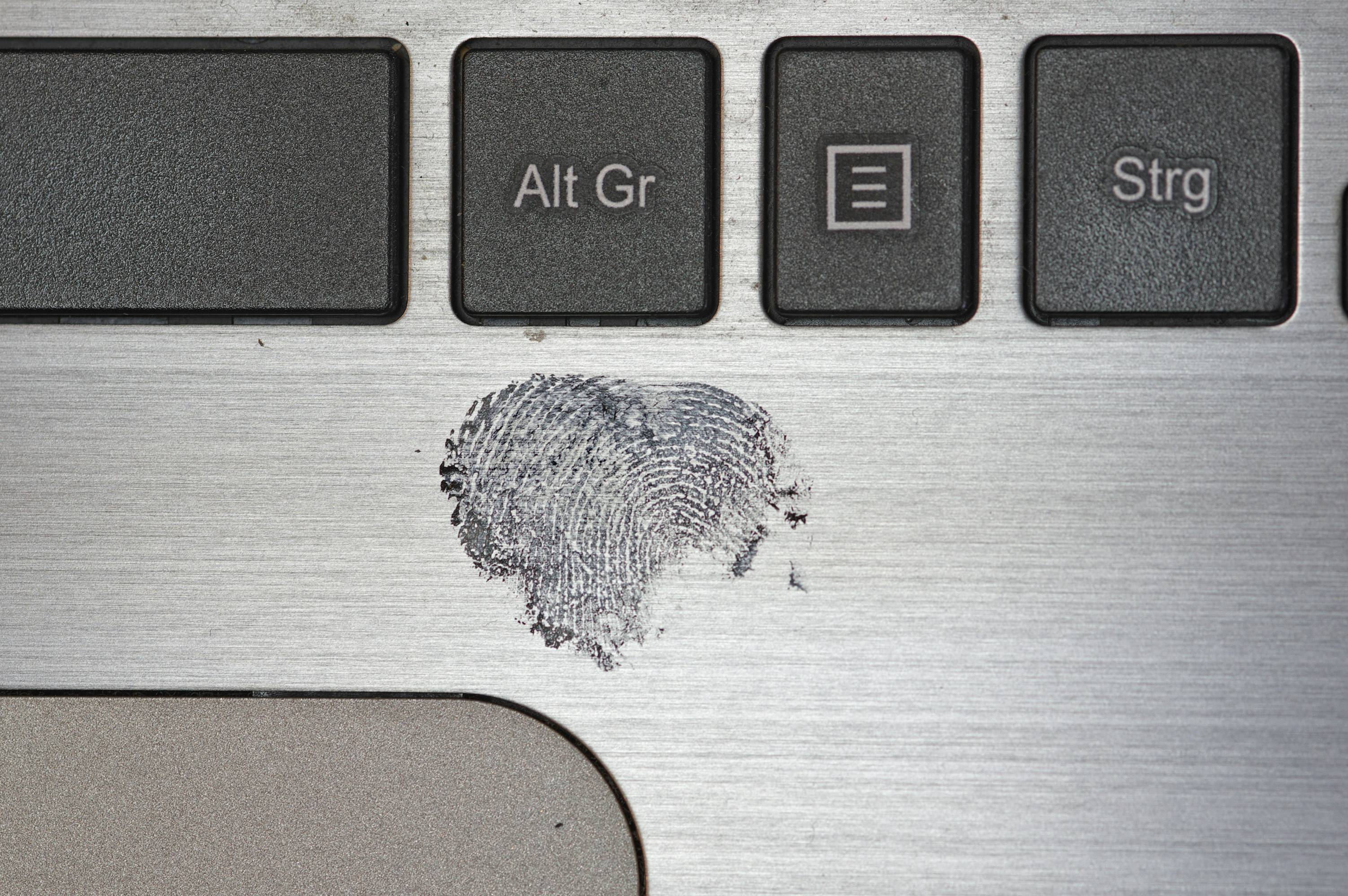 An image of keyboard and fingerprint