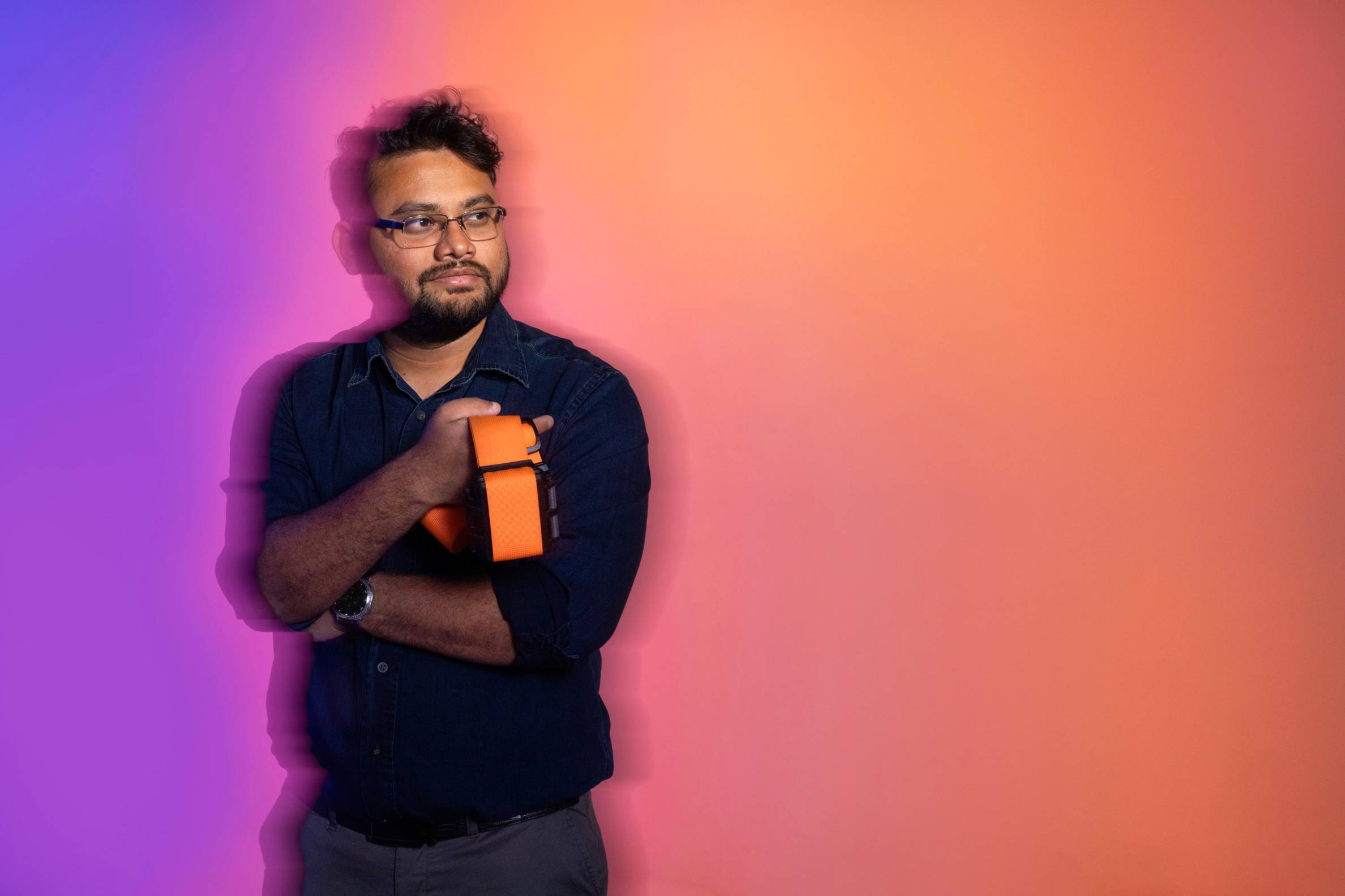 stylized photo of Ahmed Tanvir holding the device he created
