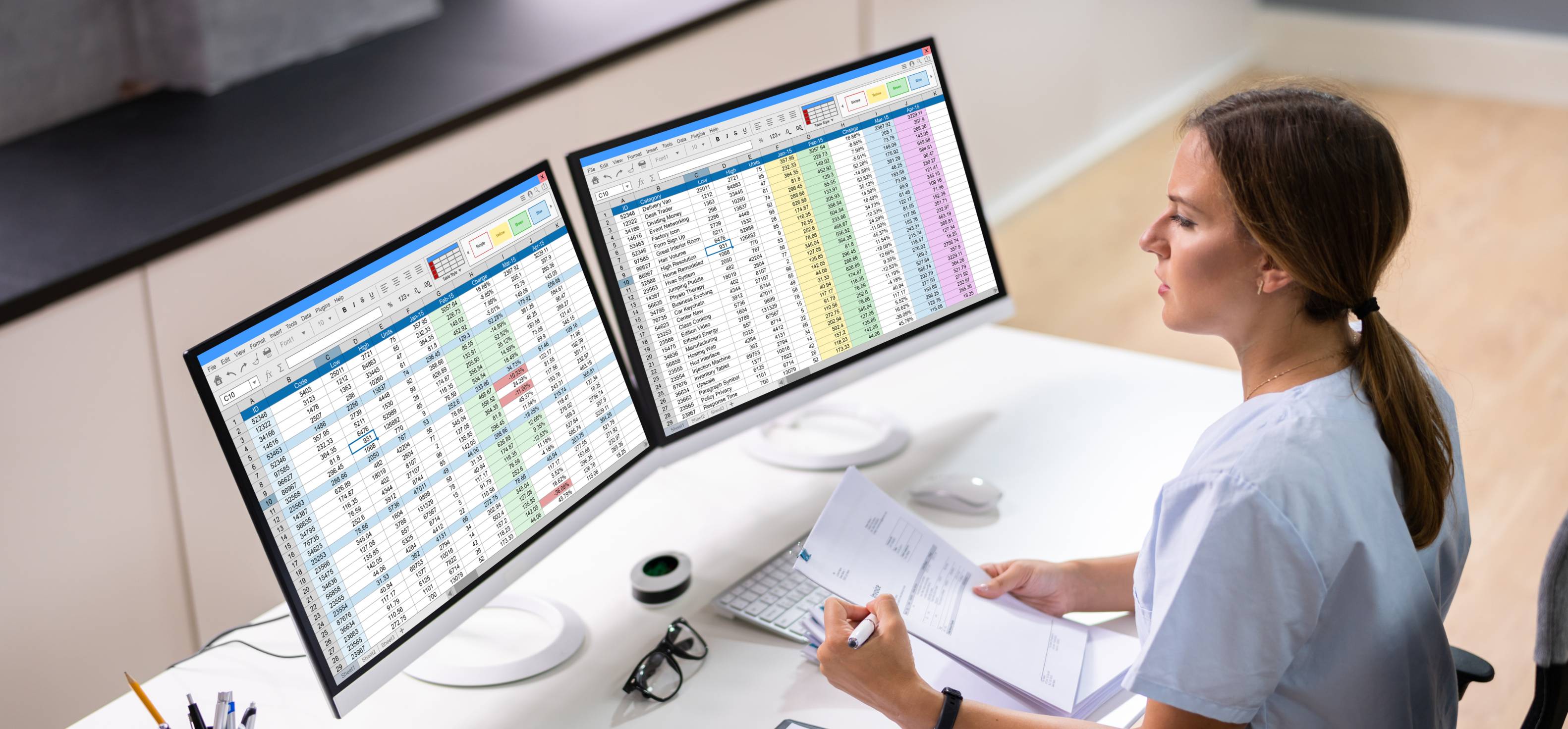 a woman scanning documents and looking at monitors
