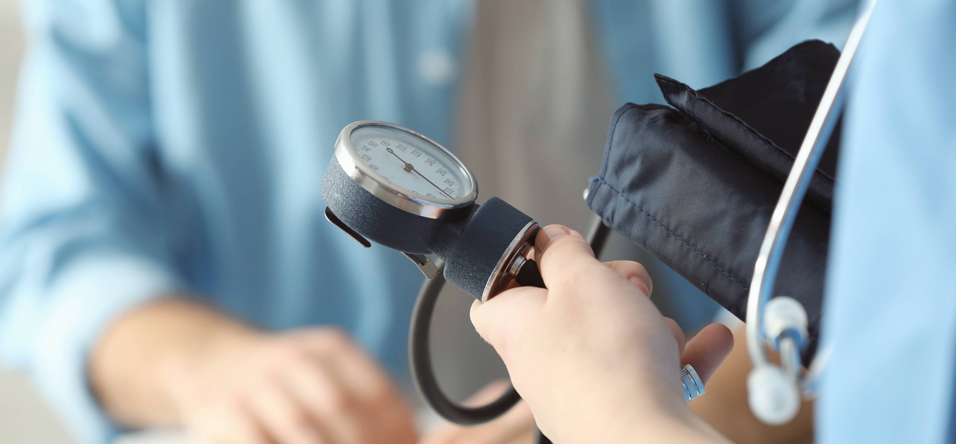 a nurse holding a blood pressure machine