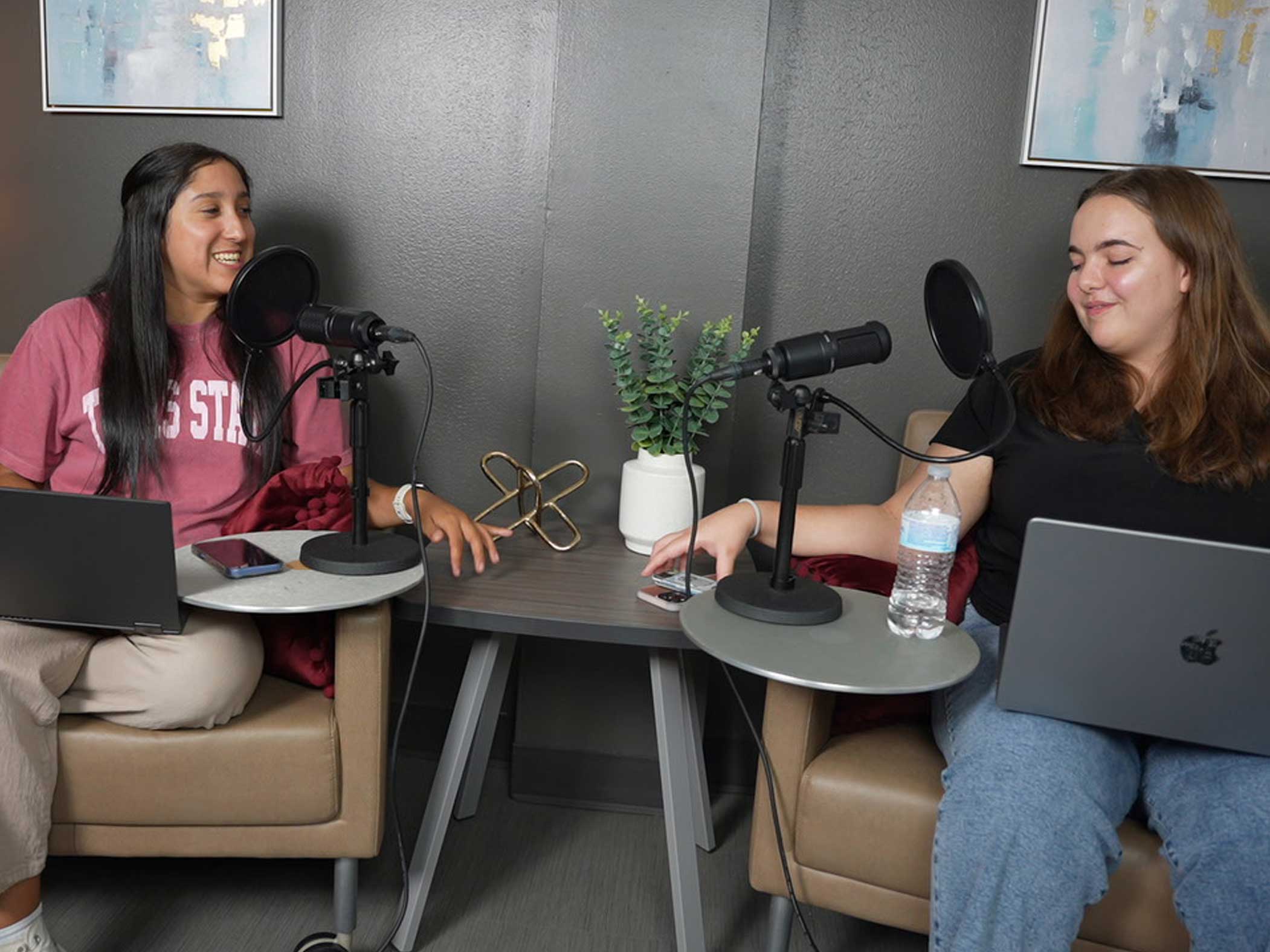 Two students using the Creator Studio to work on a podcast