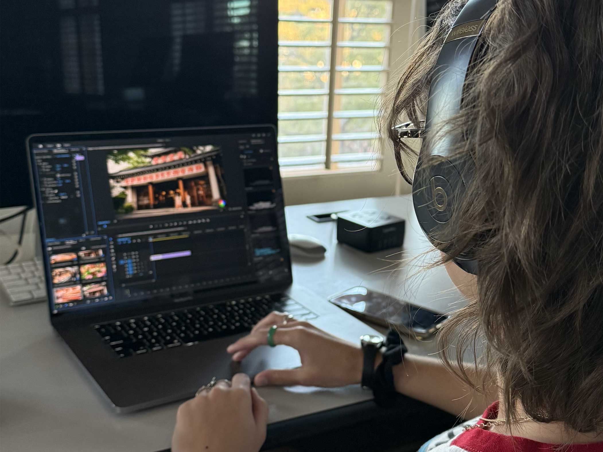 Student editing a video for the social media video course