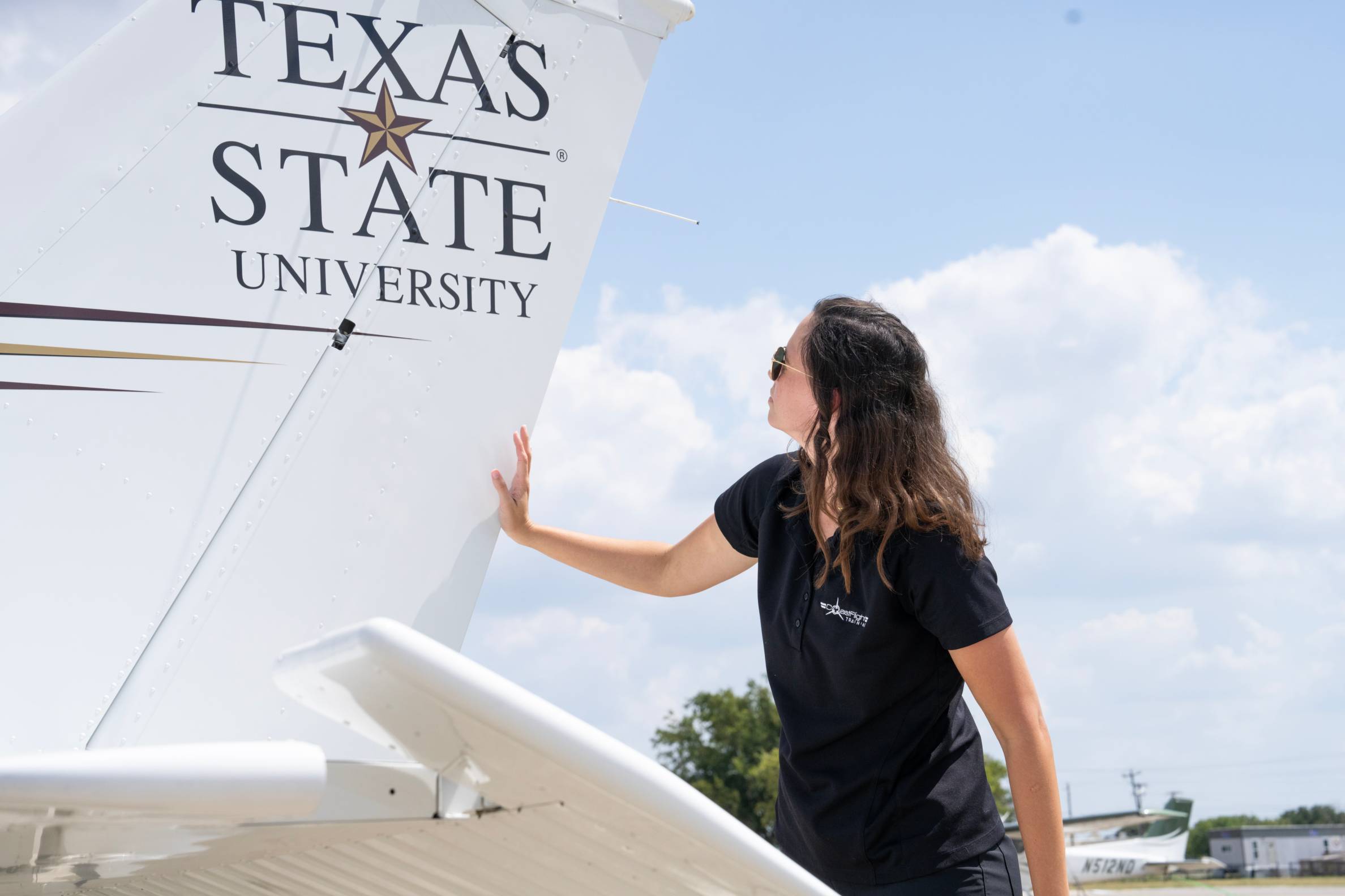 Student looking at school symbol on a plane. 