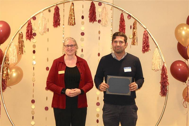 Library director handing out the certificate to the second place winner team Perez