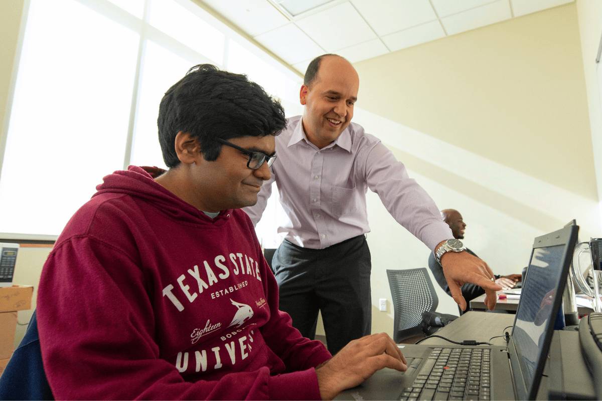 A professor guiding a student one-one-one