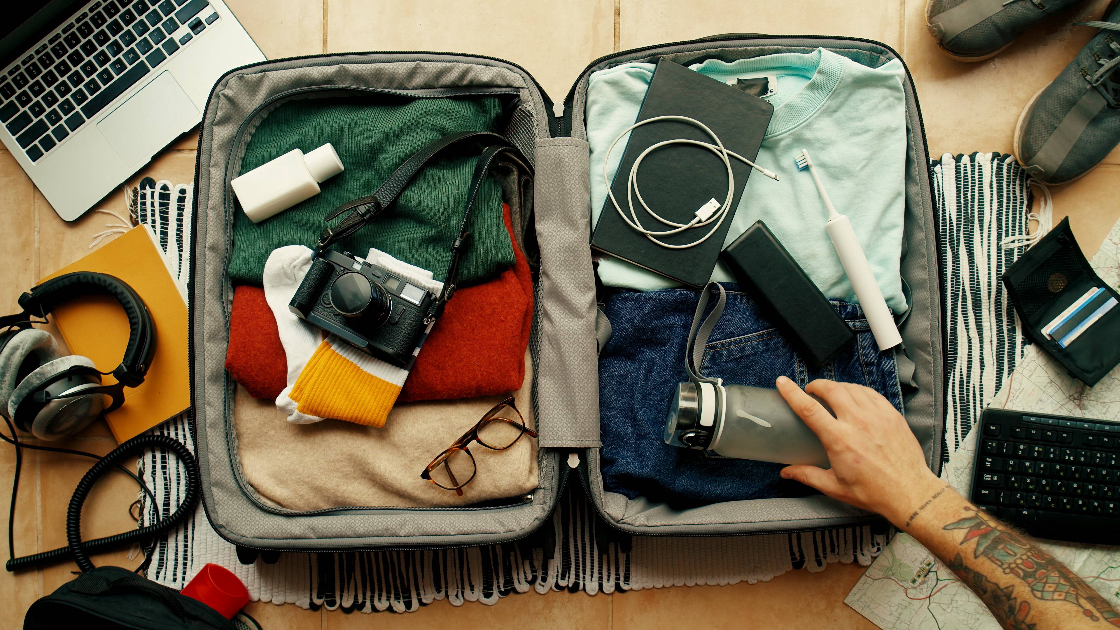birds eye view of person packing suitcase